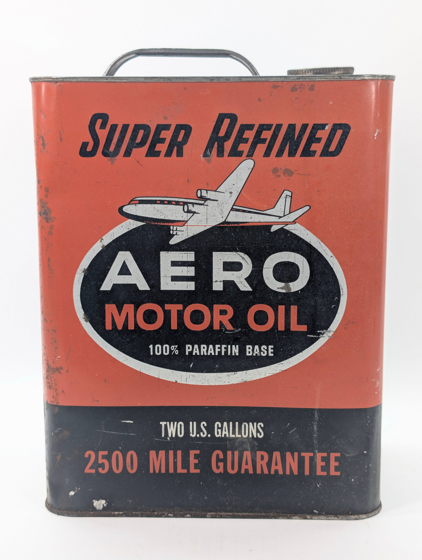 AERO MOTOR OIL TWO GALLON CAN: REMAINS IN FAIR CONDITION, SHOWING SOME TYPICAL WEAR THROUGHOUT.
