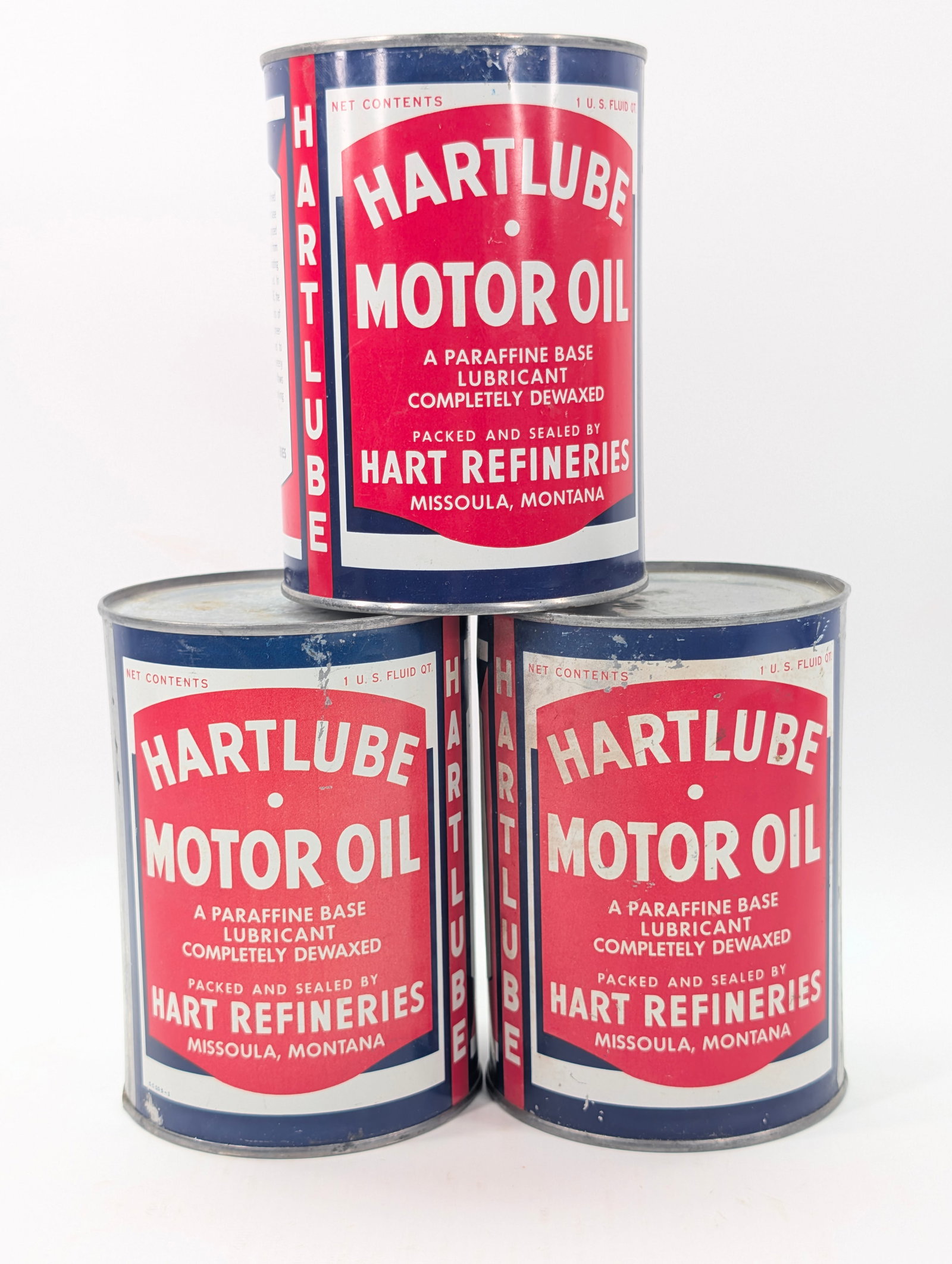 3) HARTLUBE ONE QUART MOTOR OIL CANS: ALL REMAIN IN GOOD UNOPENED CONDITION. SHOWING SOME TYPICAL WEAR.