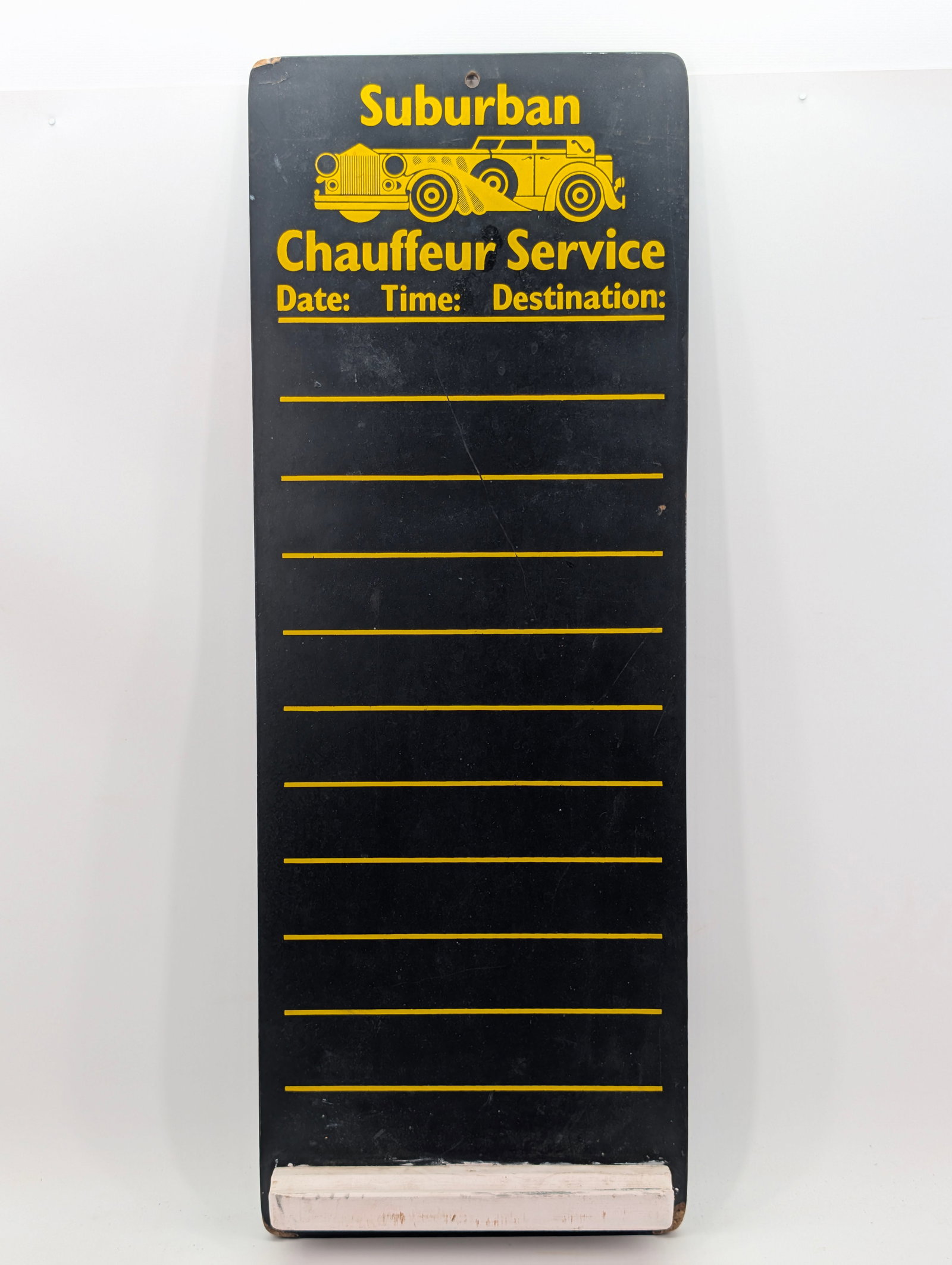 SUBURBAN CHAUFFEUR SERVICE MASONITE SIGN: REMAINS IN GOOD CONDITION, SHOWING SOME TYPICAL WEAR.