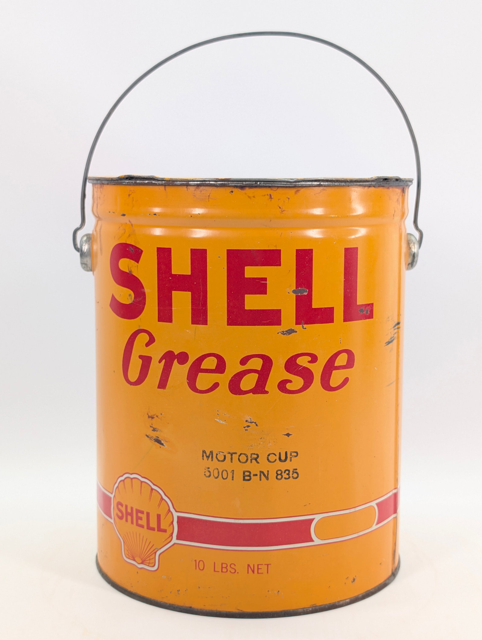 SHELL GREASE MOTOR CUP 10 POUND BUCKET: REMAINS IN GOOD CONDITION, SHOWING SOME TYPICAL USAGE WEAR.