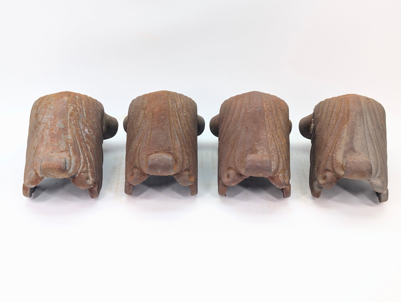 4) ANTIQUE ORNATE CAST IRON FURNITURE FEET: ALL REMAIN IN GOOD CONDITION, SHOWING TYPICAL WEAR.