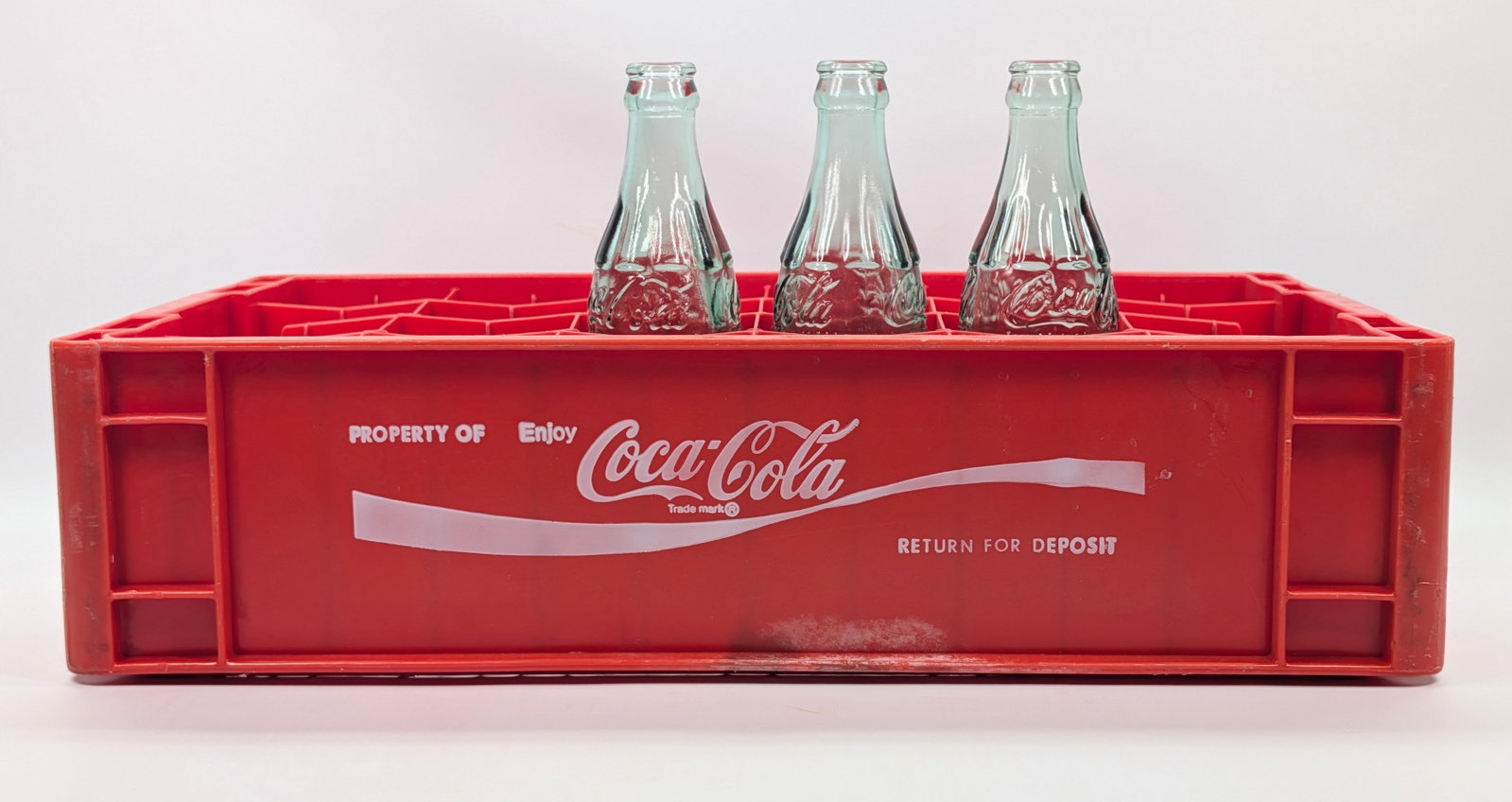 PLASTIC COCA COLA CARRIER W/ BOTTLES: REMAINS IN GOOD CONDITION.