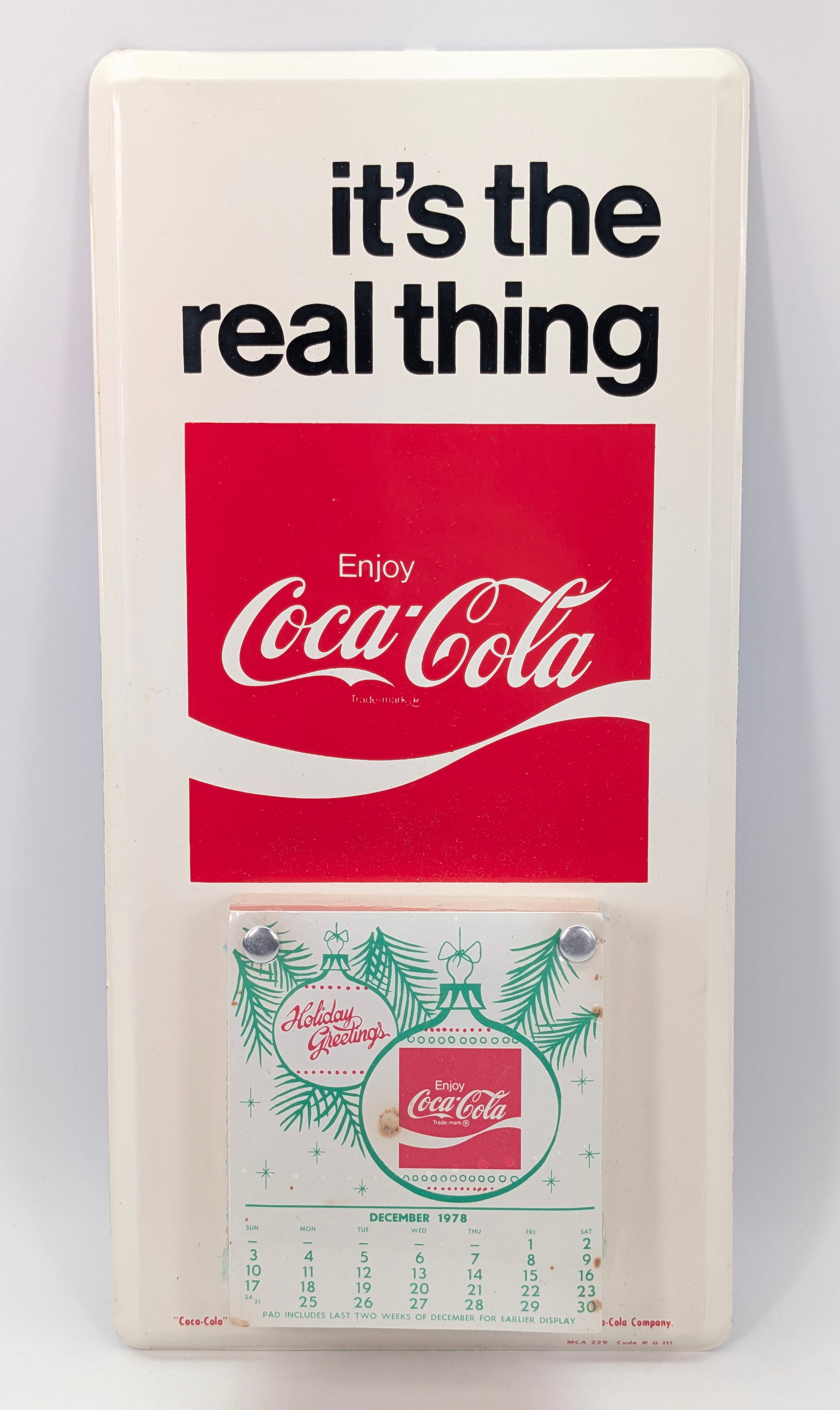 VINTAGE 1970'S COCA COLA HOLIDAY METAL CALENDAR SIGN: REMAINS IN VERY GOOD UNUSED CONDITION.