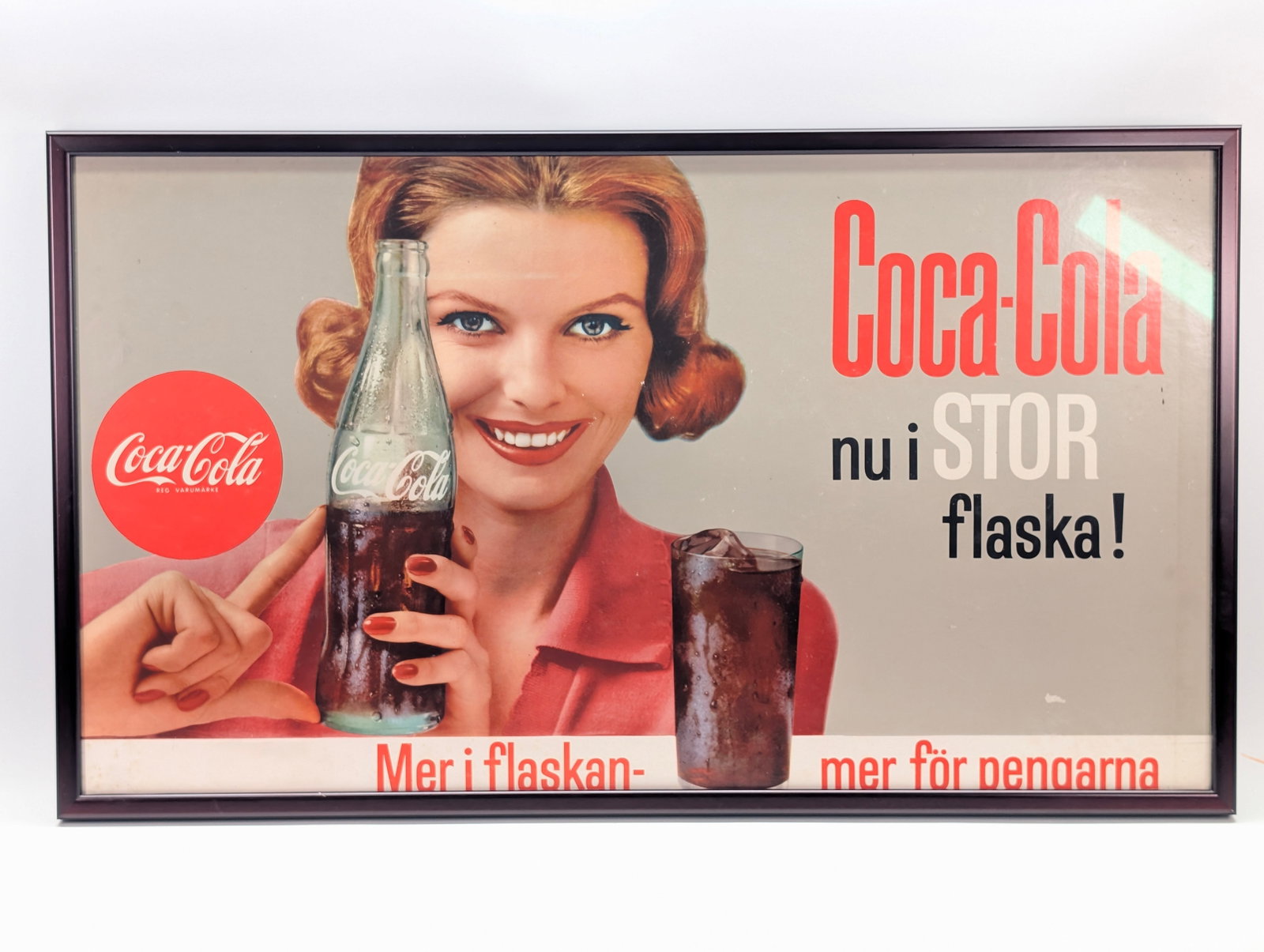 VINTAGE SWEDISH COCA COLA ADVERTISEMENT FRAMED: REMAINS IN GOOD CONDITION, SHOWING LIGHT WEAR.