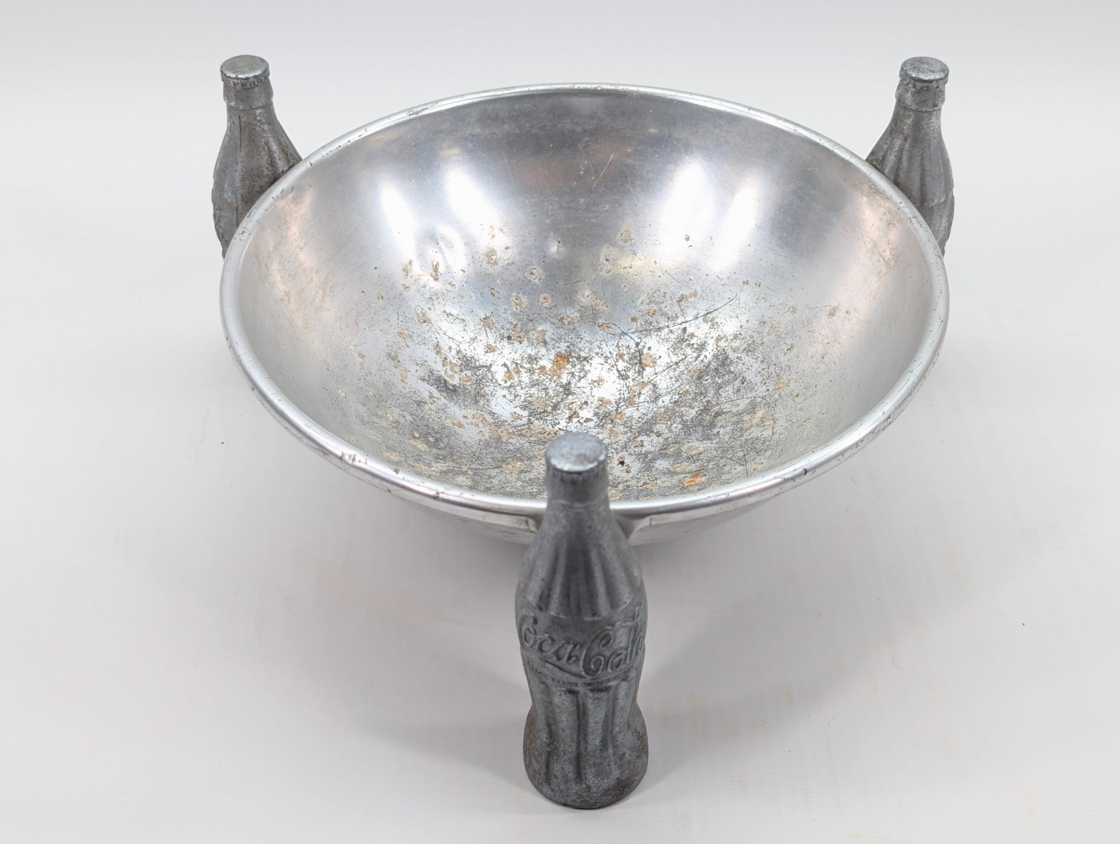 VINTAGE METAL COCA COLA BOTTLE CANDY BOWL: REMAINS IN FAIR TO GOOD CONDITION, SHOWING TYPICAL WEAR THROUGHOUT.
