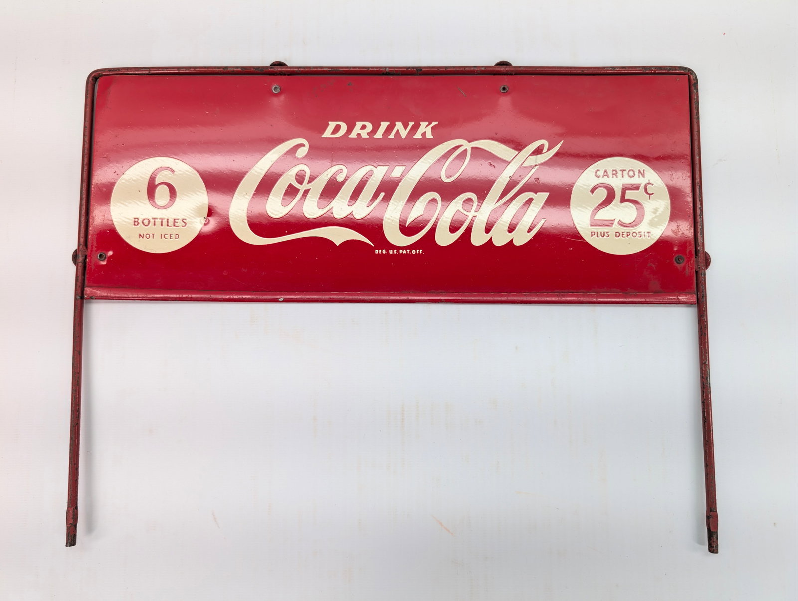 METAL COCA COLA 25 CENT SIGN RACK TOPPER: REMAINS IN GOOD CONDITION, SHOWING A FEW BENDS.