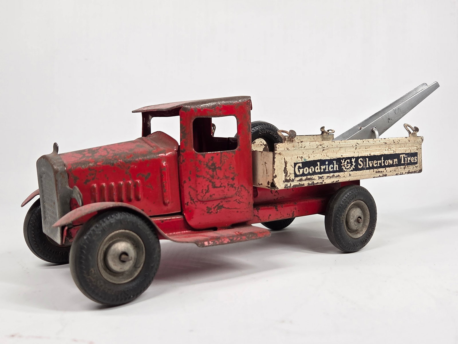 METALCRAFT PRESSED STEEL GOODRICH TIRES TOW TRUCK: REMAINS IN FAIR TO GOOD CONDITION, SHOWING TYPICAL USAGE WEAR. METAL BOOM APPEARS TO BE A REPLACEMENT.