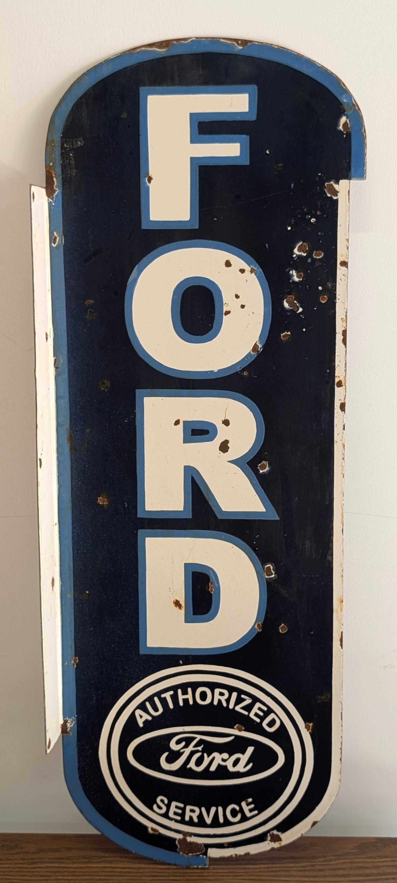 REPRODUCTION FORD PORCELAIN FLANGE SIGN: REMAINS IN GOOD CONDITION, SHOWING SOME RUST CHIPS.