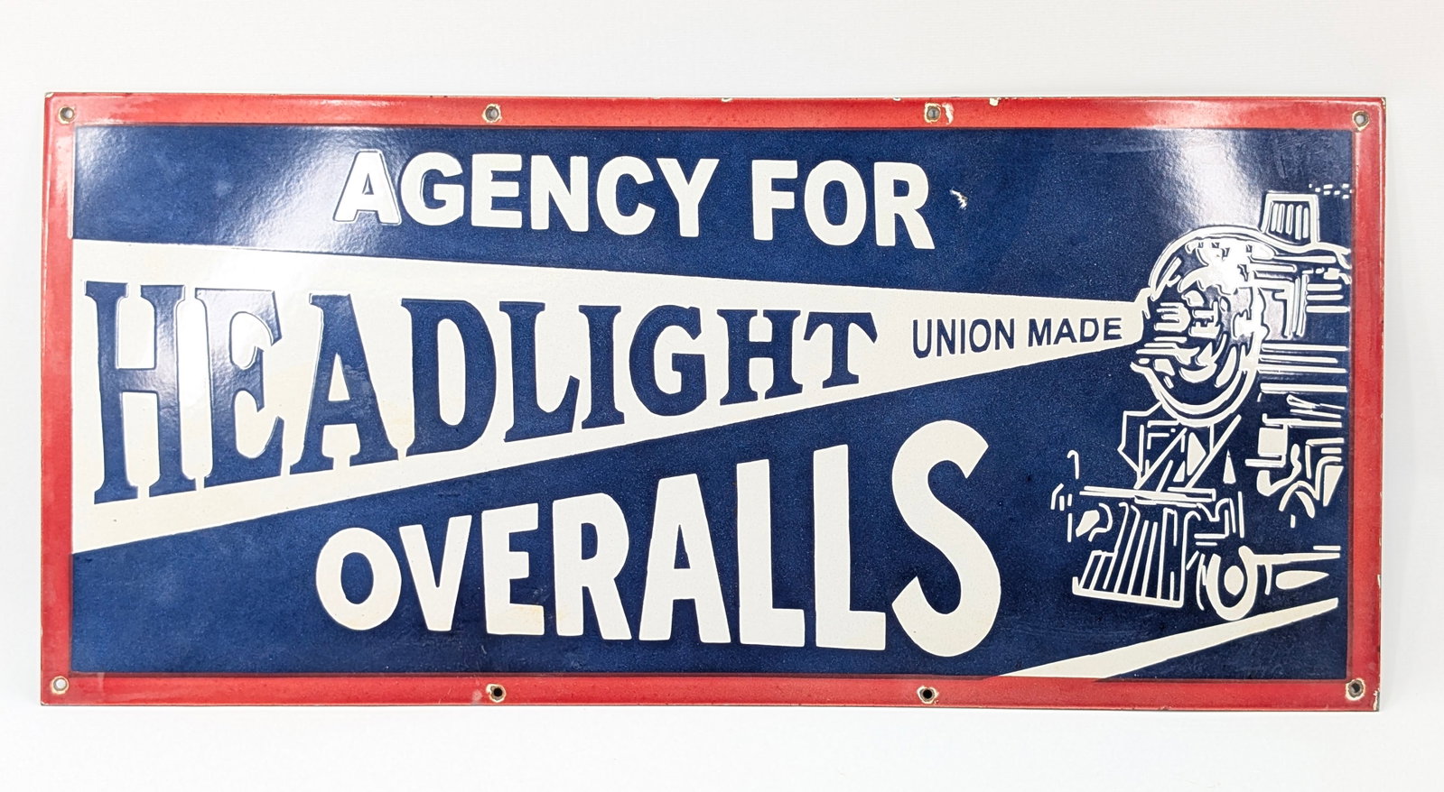 REPRODUCTION HEADLIGHT OVERALLS PORCELAIN SIGN: REMAINS IN GOOD CONDITION, SHOWING LIGHT CHIPS.
