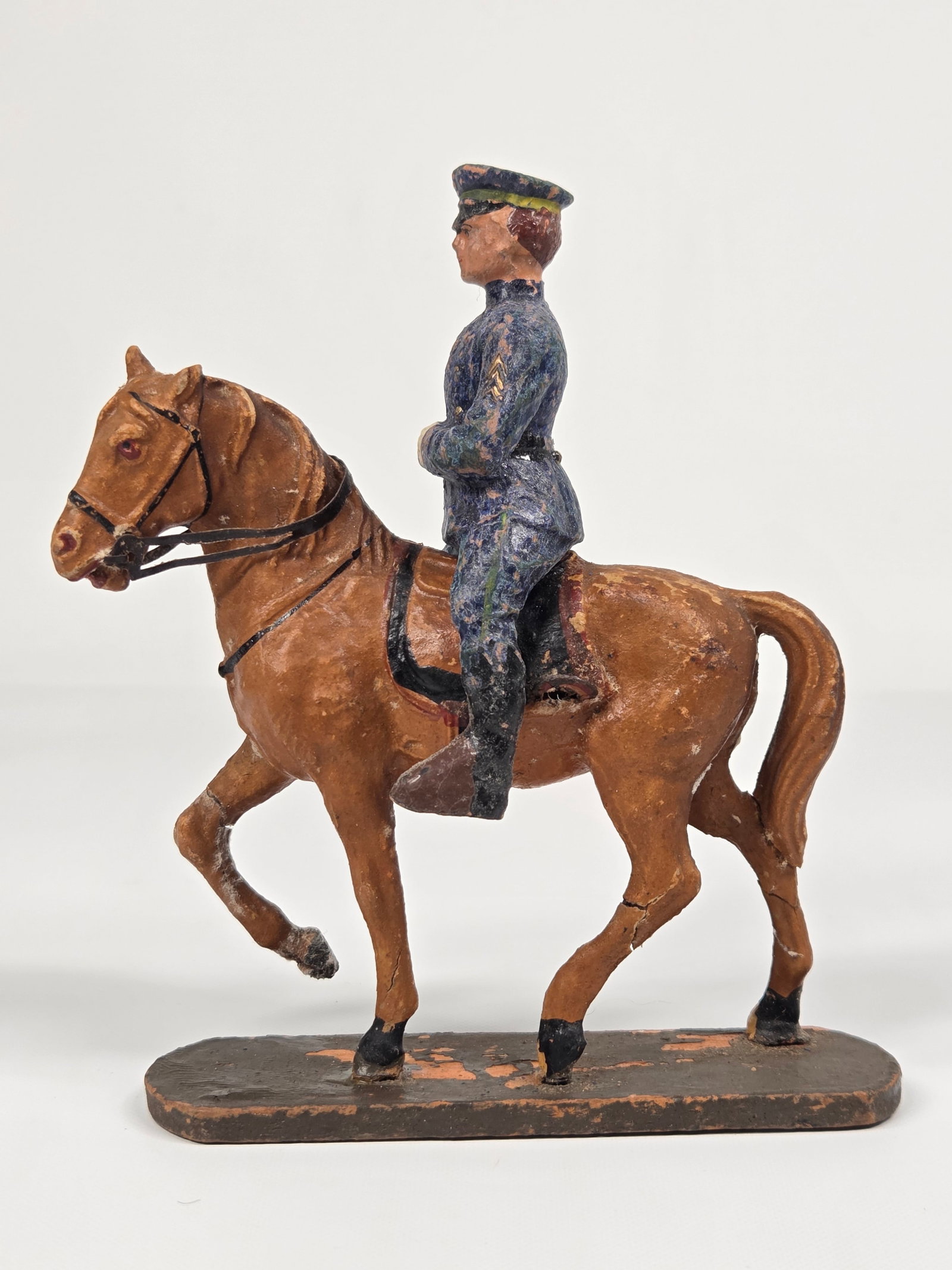 ANTIQUE PAINTED COMPOSITION MILITARY OFFICER MOUNTED: REMAINS IN FAIR CONDITION, SHOWING PAINT WEAR THROUGHOUT. HOSE HAS CRACKS IN THREE LEGS.