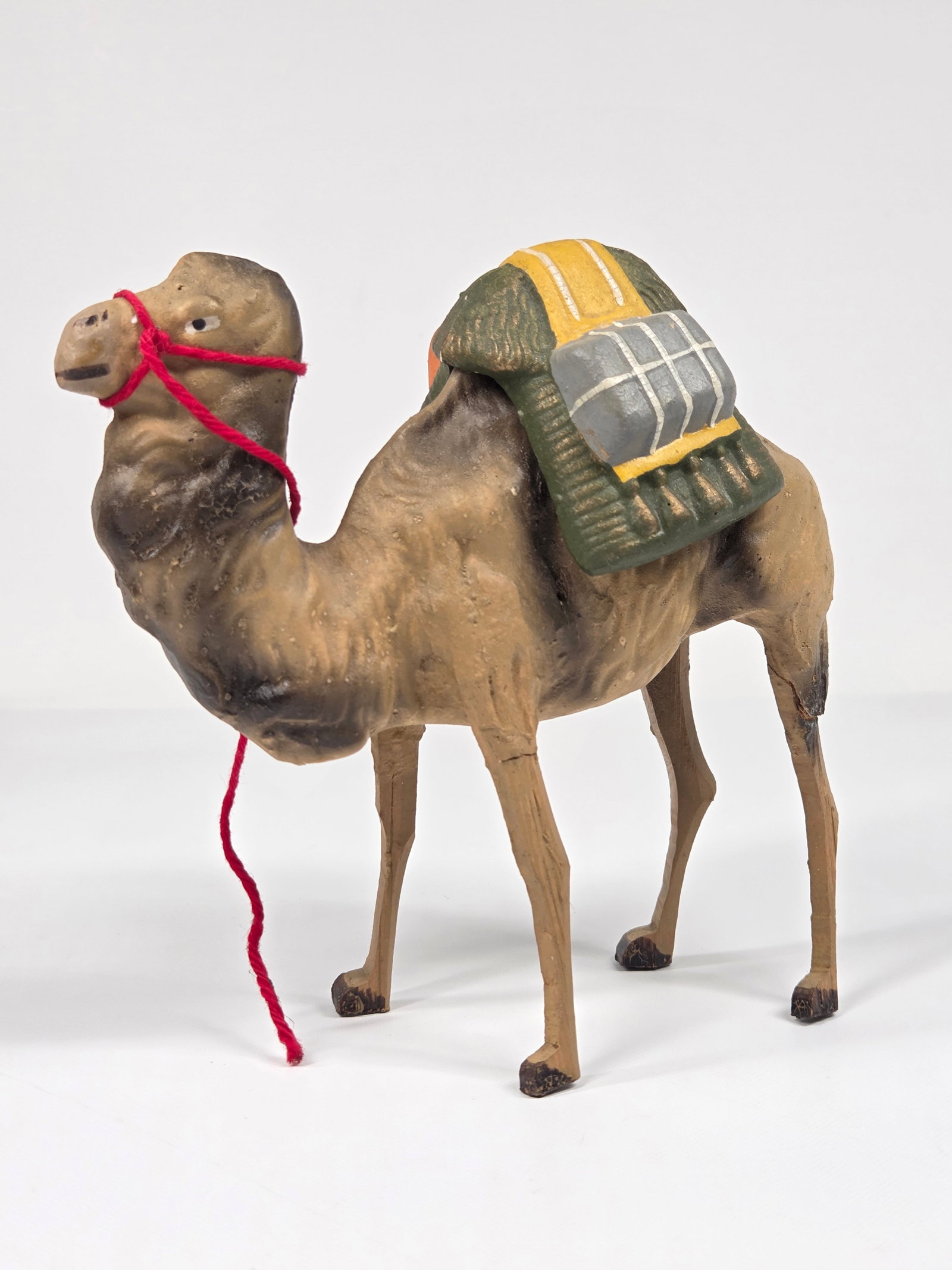 ANTIQUE GERMAN PUTZ COMPOSITION CAMEL W/ SADDLE: REMAINS IN GOOD CONDITION, SHOWING SOME LIGHT TYPICAL WEAR. EACH LEG WITH CRACK.