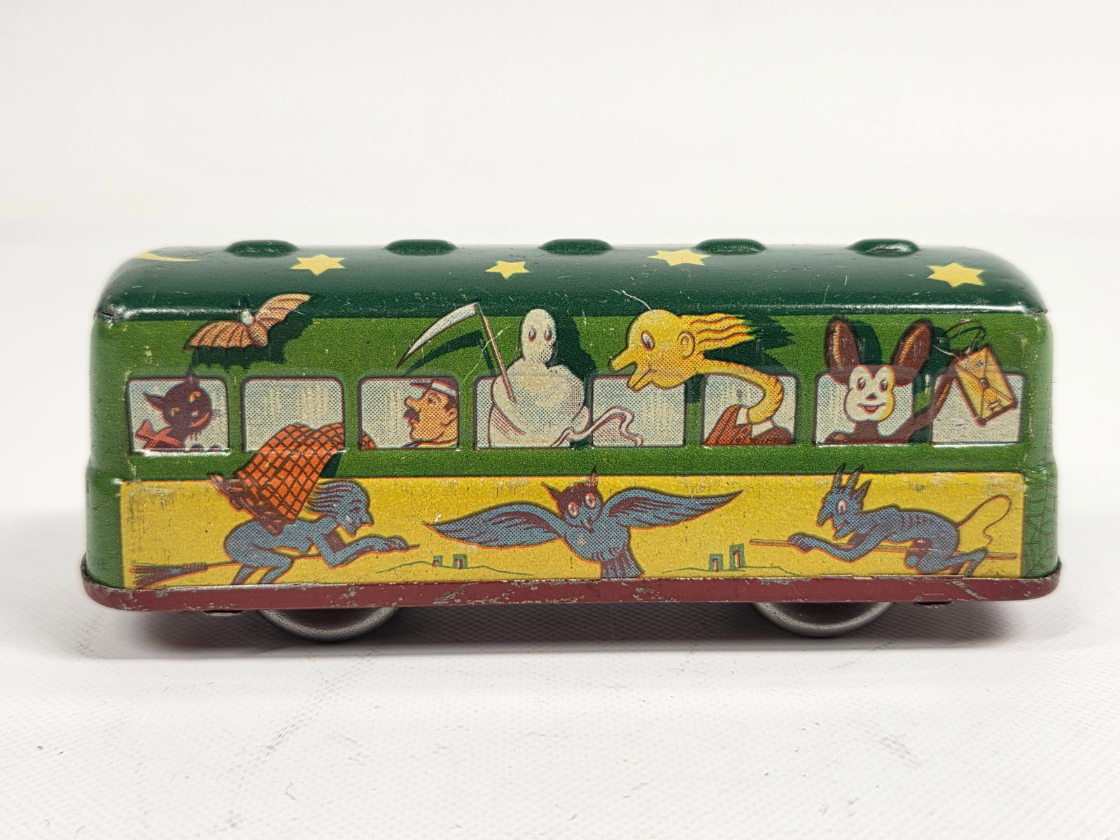 US ZONE GERMANY TIN WIND UP HALLOWEEN BUS W/ GHOST, DEVIL & WITCH: REMAINS IN GOOD CONDITION, SHOWING SOME TYPICAL WEAR.