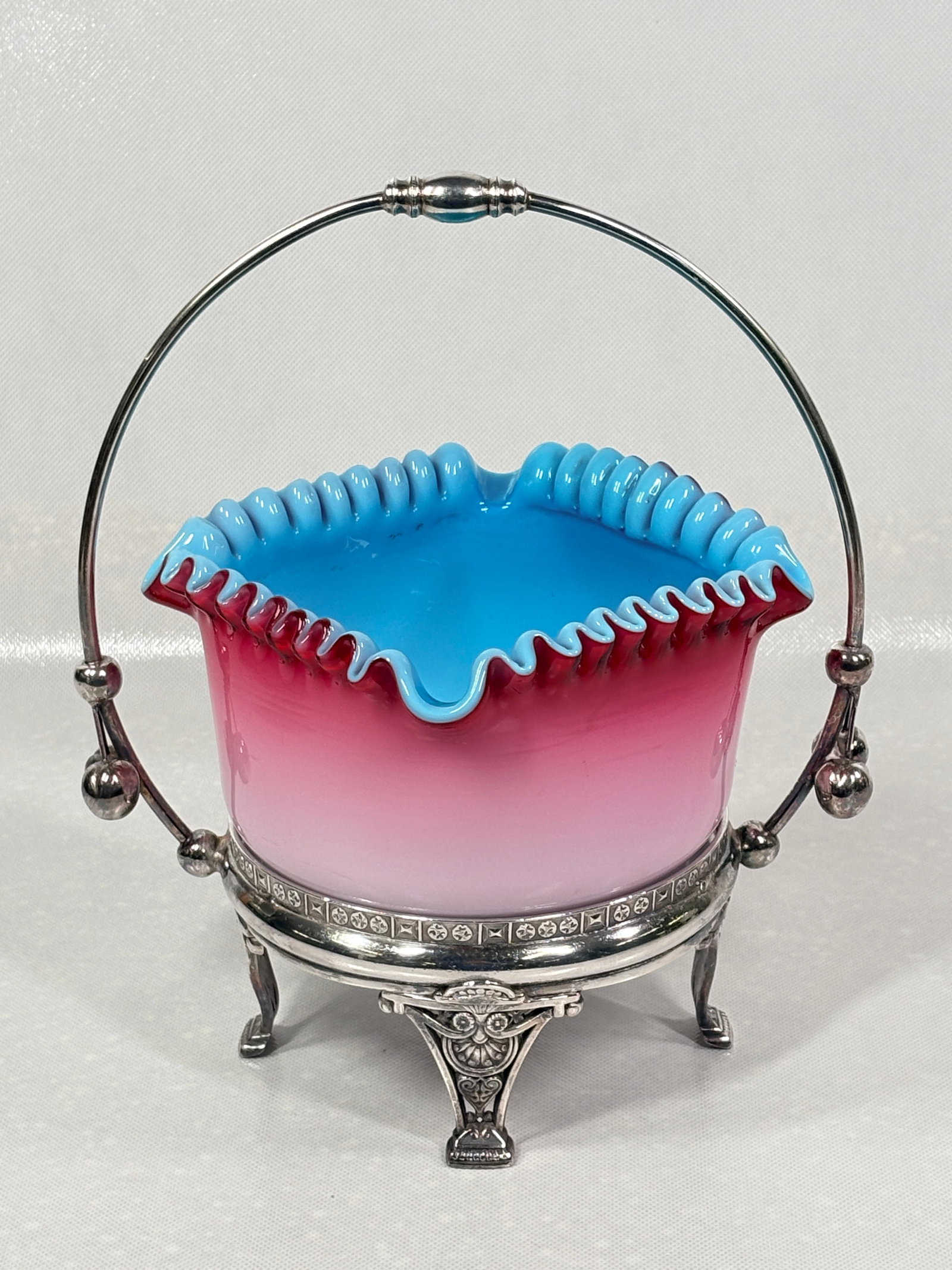 VICTORIAN ERA MT. WASHINGTON PINK TO BLUE CASED GLASS BRIDES BASKET: GLASS REMAINS IN VERY GOOD CLEAN CONDITION. SILVER PLATE CASTOR REMAINS VERY NICE AND CLEAN, POLISHED.