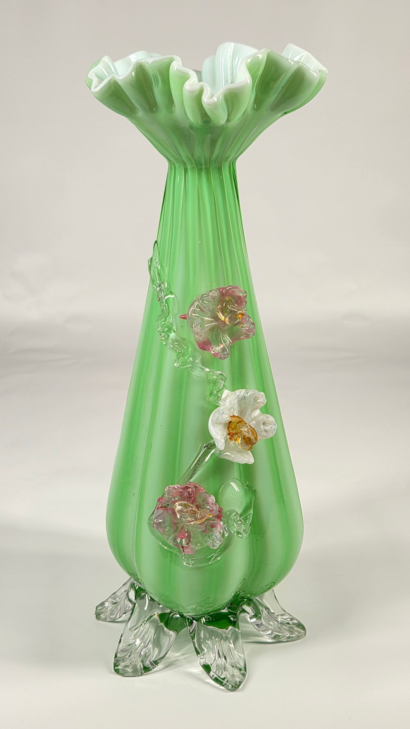 ANTIQUE VICTORIAN GREEN CASED GLASS VASE W/ APPLIED FLOWERS: REMAINS IN GOOD CONDITION. A FEW OF THE FEET HAVE SMALL CHIPS ON THE TIPS.