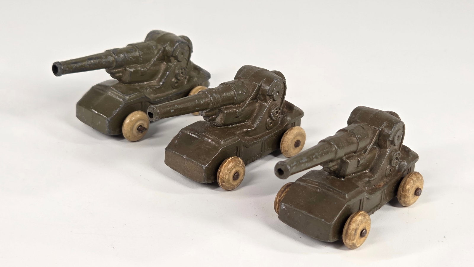 3) BARCLAY MANOIL SLUSH METAL MILITARY CANNONS: ALL REMAIN IN FAIR TO GOOD CONDITION, SHOWING SOME TYPICAL PAINT WEAR.