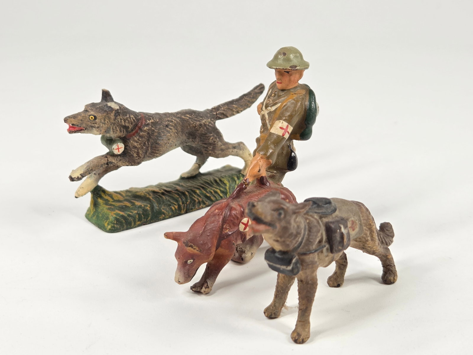 GERMAN ELASTOLIN SOLDIER W/ DOGS: ALL REMAIN IN FAIR TO GOOD CONDITION, SHOWING SOME CRACKS.