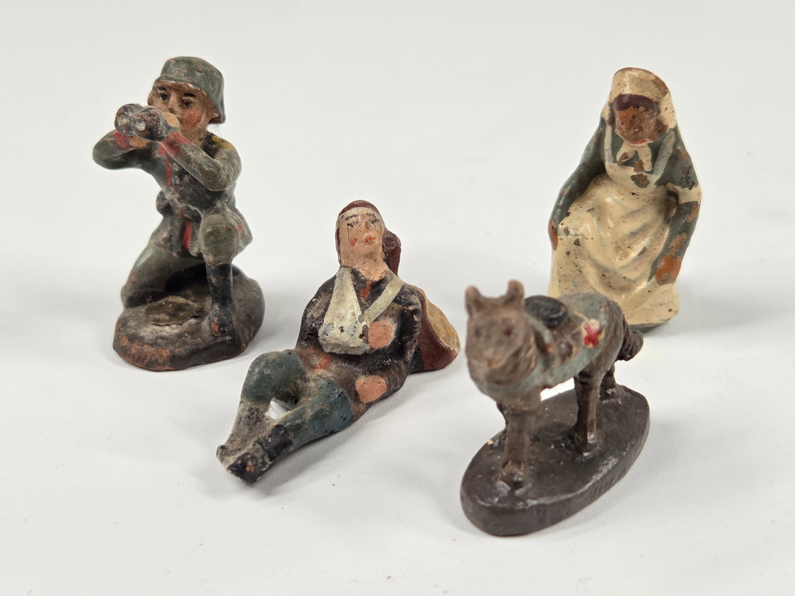 4) GERMAN ELASTOLIN COMPOSITION SOLDIERS: ALL REMAIN IN FAIR TO GOOD CONDITION, SHOWING PAINT WEAR.
