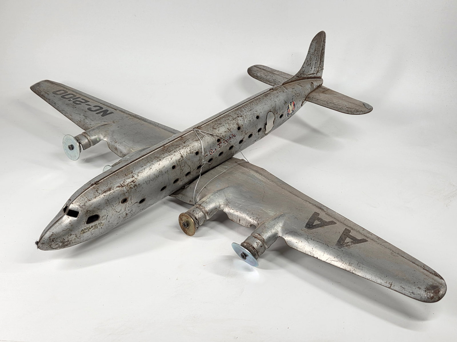 LARGE PRESSED STEEL FLAGSHIP AIRPLANE: REMAINS IN FAIR CONDITION, SHOWING TYPICAL USAGE WEAR. MISSING ALL PROPELLERS.