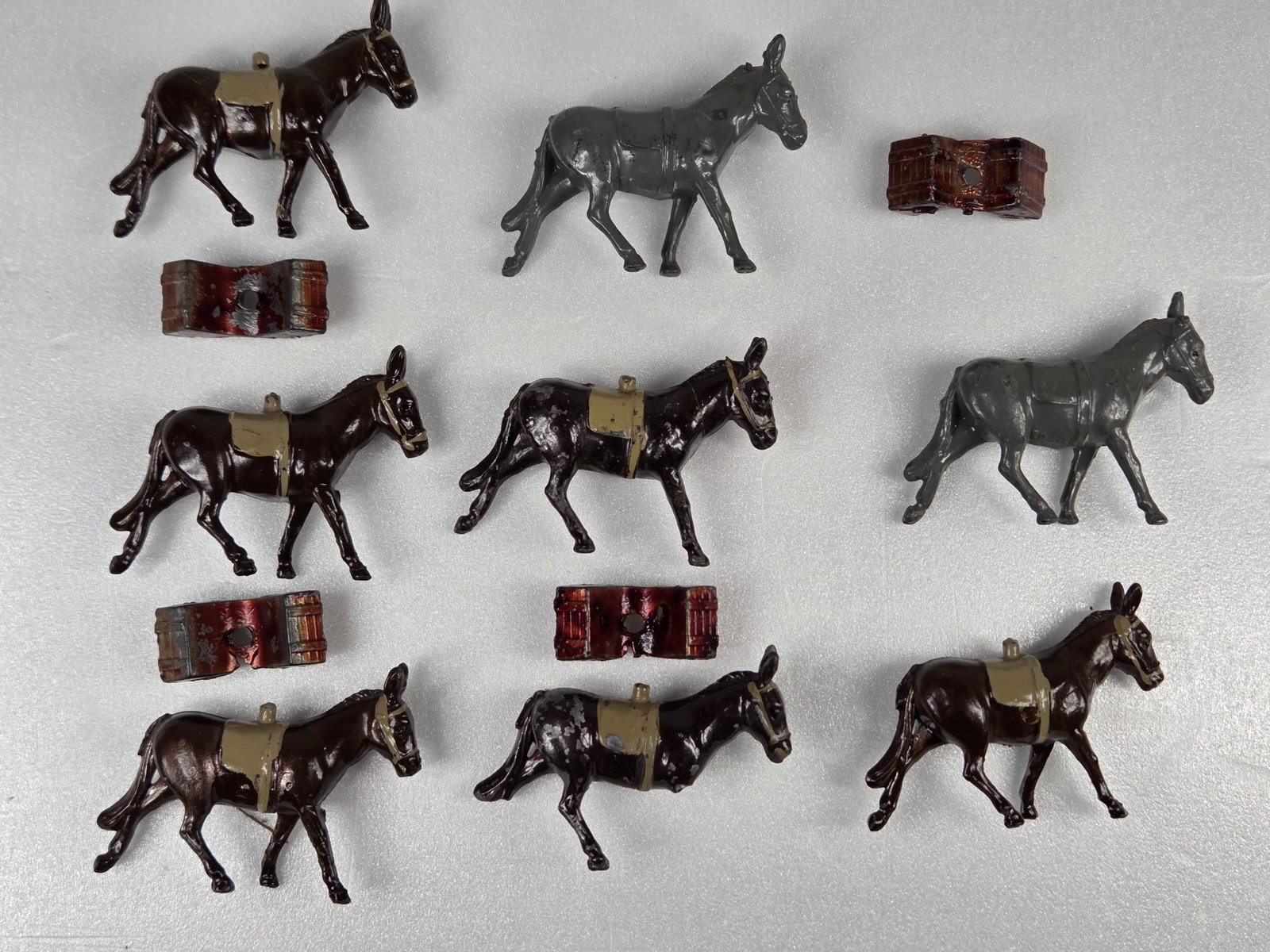 8) PAINTED LEAD DONKEYS WITH PACKS: ALL REMAIN IN GOOD CONDITION, SHOWING SOME TYPICAL WEAR, LOSS