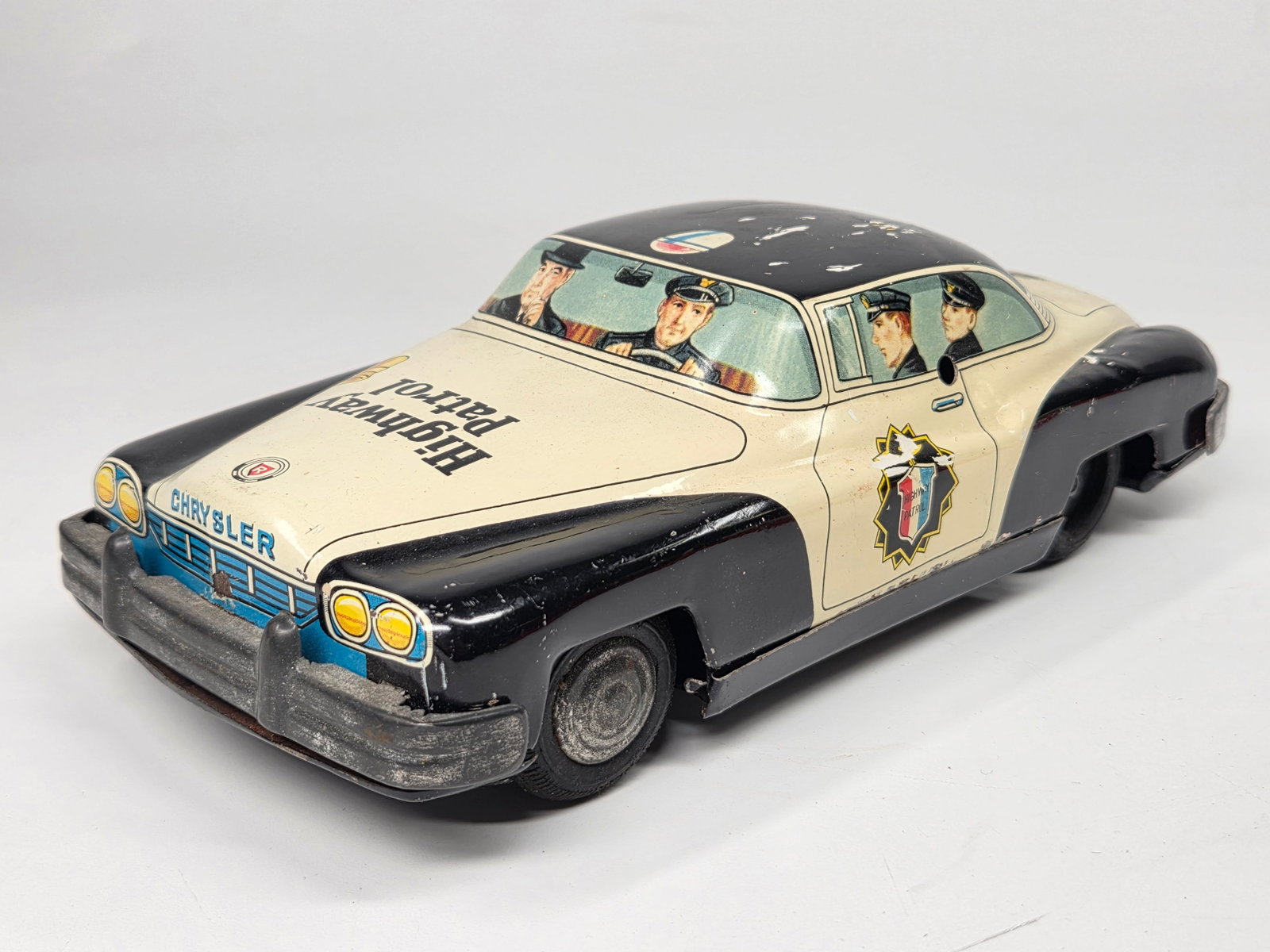 JAPAN TIN FRICTION CHRYSLER HIGHWAY PATROL CAR: REMAINS IN GOOD CONDITION, SHOWING SOME TYPICAL USAGE WEAR. FRICTION MOTOR WORKS.