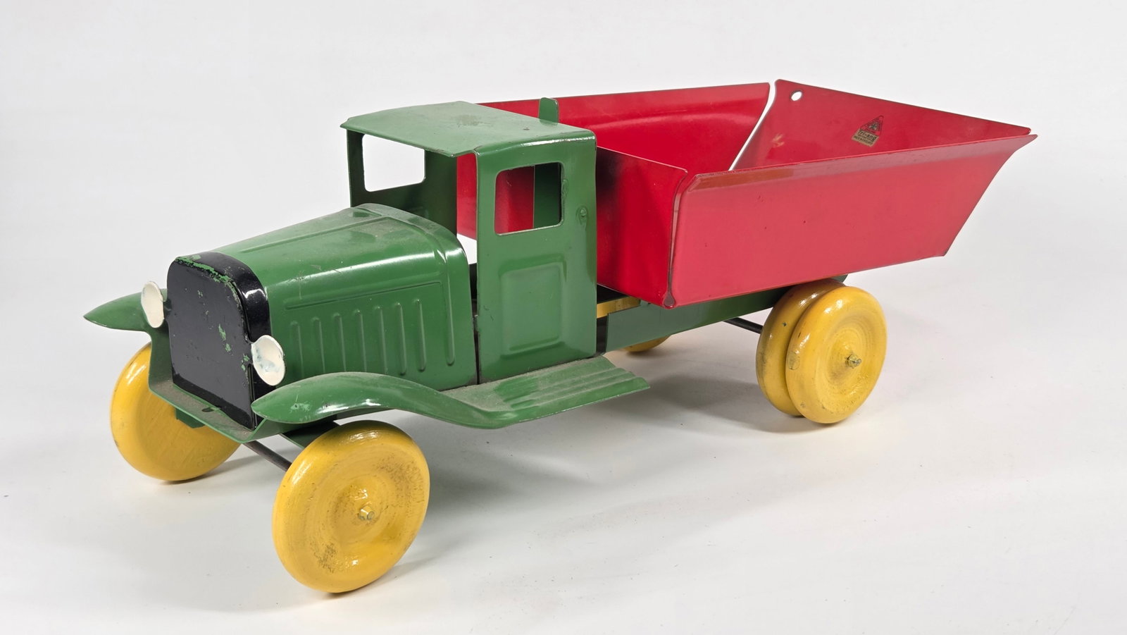 RESTORED PRESSED STEEL DUMP TRUCK W/ TRI-ANG DECAL: REMAINS IN GOOD RESTORED CONDITION, SHOWING SOME PAINT WEAR.