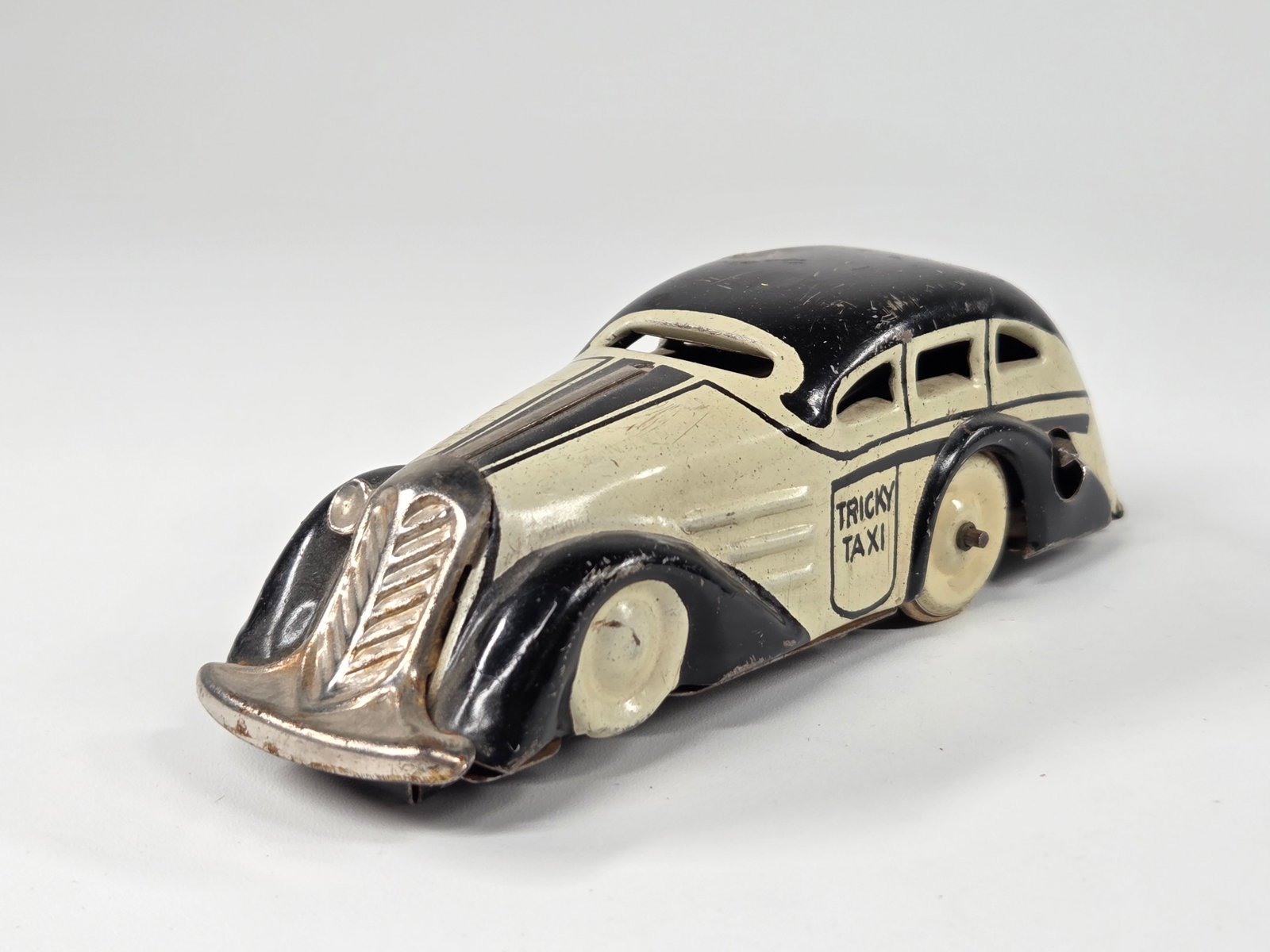 MARX WIND UP TRICKY TAXI: REMAINS IN GOOD CONDITION, SHOWING SOME TYPICAL WEAR. UNTESTED.