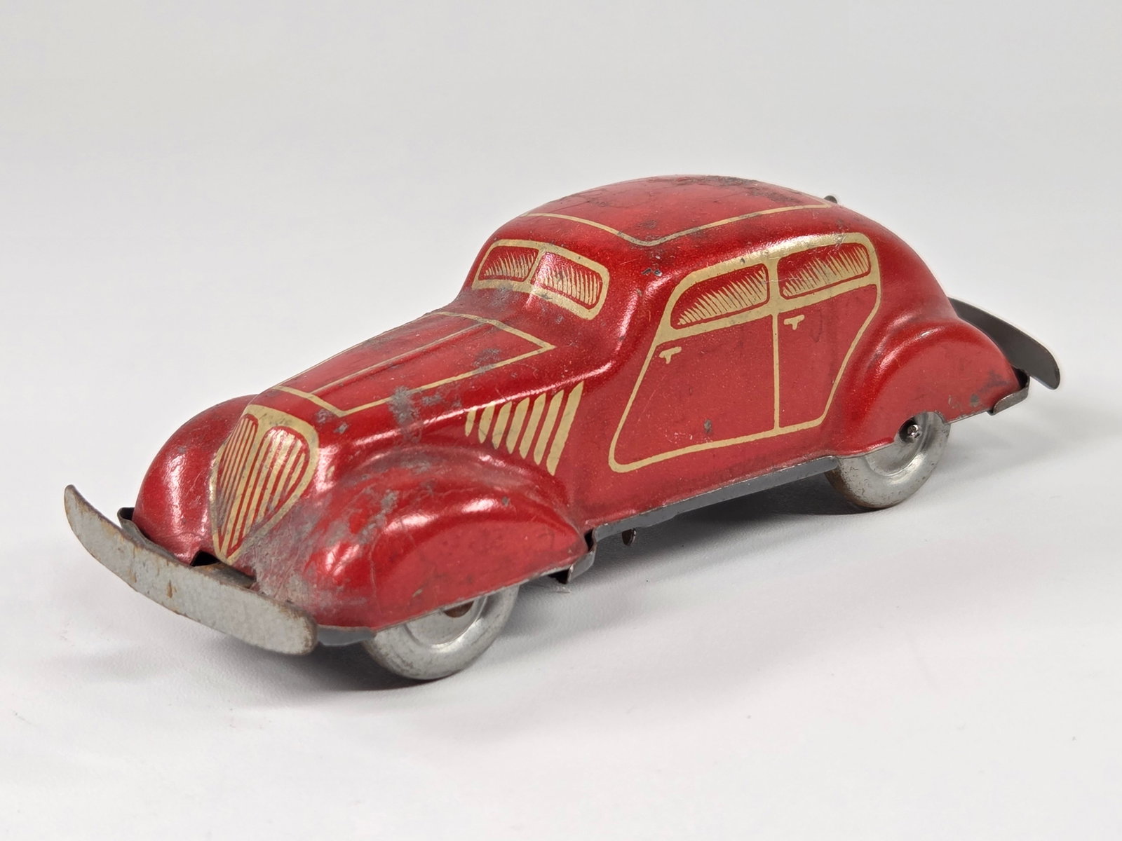US ZONE GERMANY TIN LITHO WIND UP CAR - RED: REMAINS IN FAIR TO GOOD CONDITION, SHOWING SOME TYPICAL WEAR. UNTESTED.