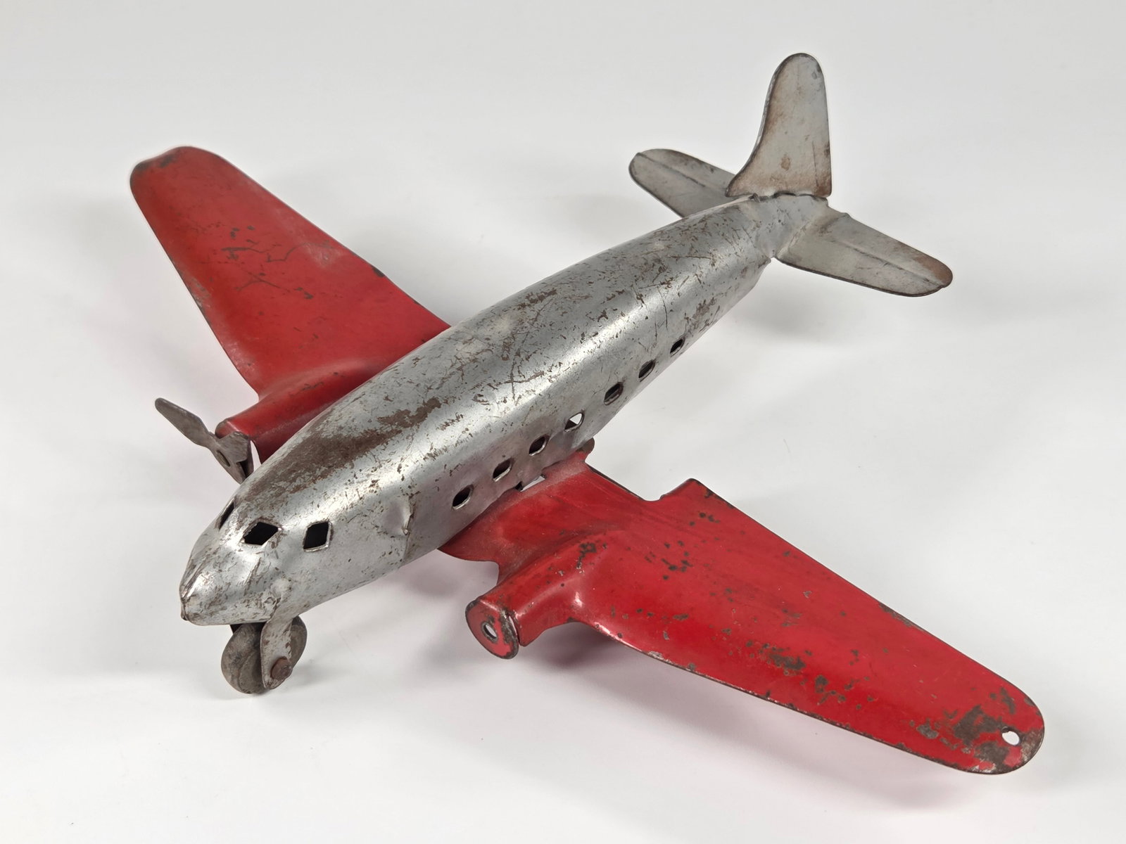MARX WYANDOTTE PRESSED STEEL AIRPLANE: REMAINS IN FAIR TO GOOD CONDITION, SHOWING SOME TYPICAL WEAR. MISSING ONE PROPELLER.