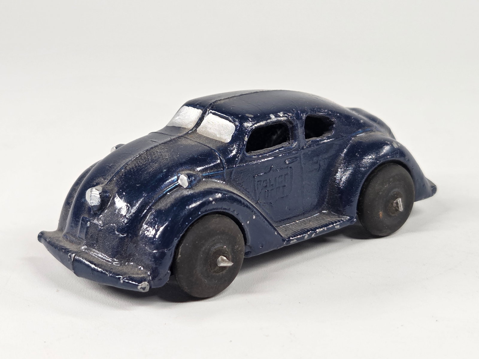 RECAST SLUSH METAL STREAMLINE POLICE DEPT. CAR: REMAINS IN GOOD CONDITION, SHOWING SOME PAINT WEAR.