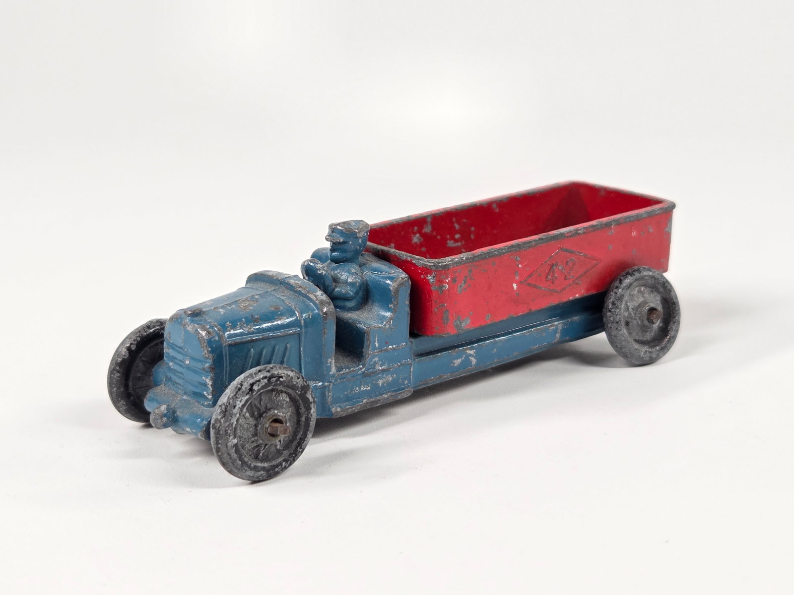 ANTIQUE SLUSH METAL DUMP TRUCK: REMAINS IN FAIR CONDITION, SHOWING TYPICAL WEAR.
