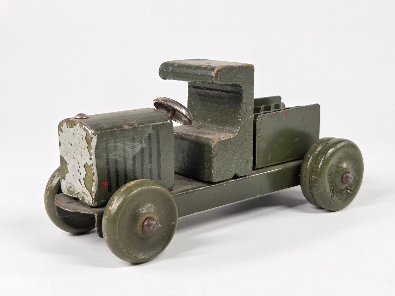 ANTIQUE WOOD & PRESSED STEEL MILITARY TRUCK: REMAINS IN FAIR CONDITION, SHOWING TYPICAL WEAR THROUGHOUT.