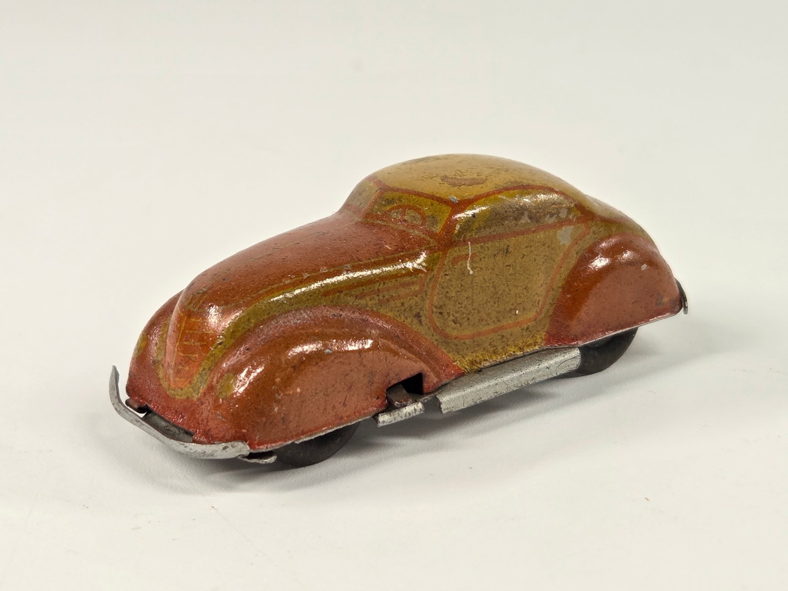 SMALL US ZONE GERMANY TIN WIND UP CAR: REMAINS IN GOOD CONDITION, SHOWING SOME TYPICAL WEAR. UNTESTED.