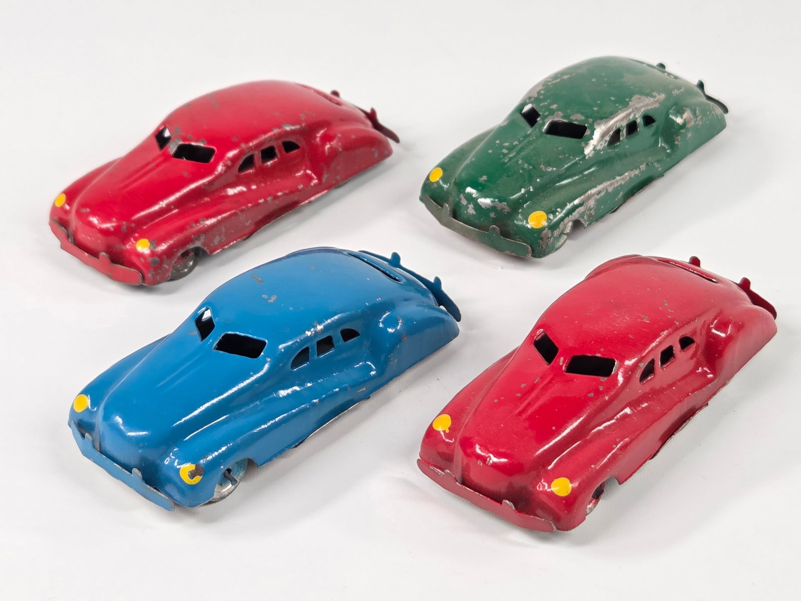 4) SMALL MINIATURE OCCUPIED JAPAN TIN LITHO CARS: ALL REMAIN IN GOOD CONDITION, SHOWING SOME PAINT WEAR.