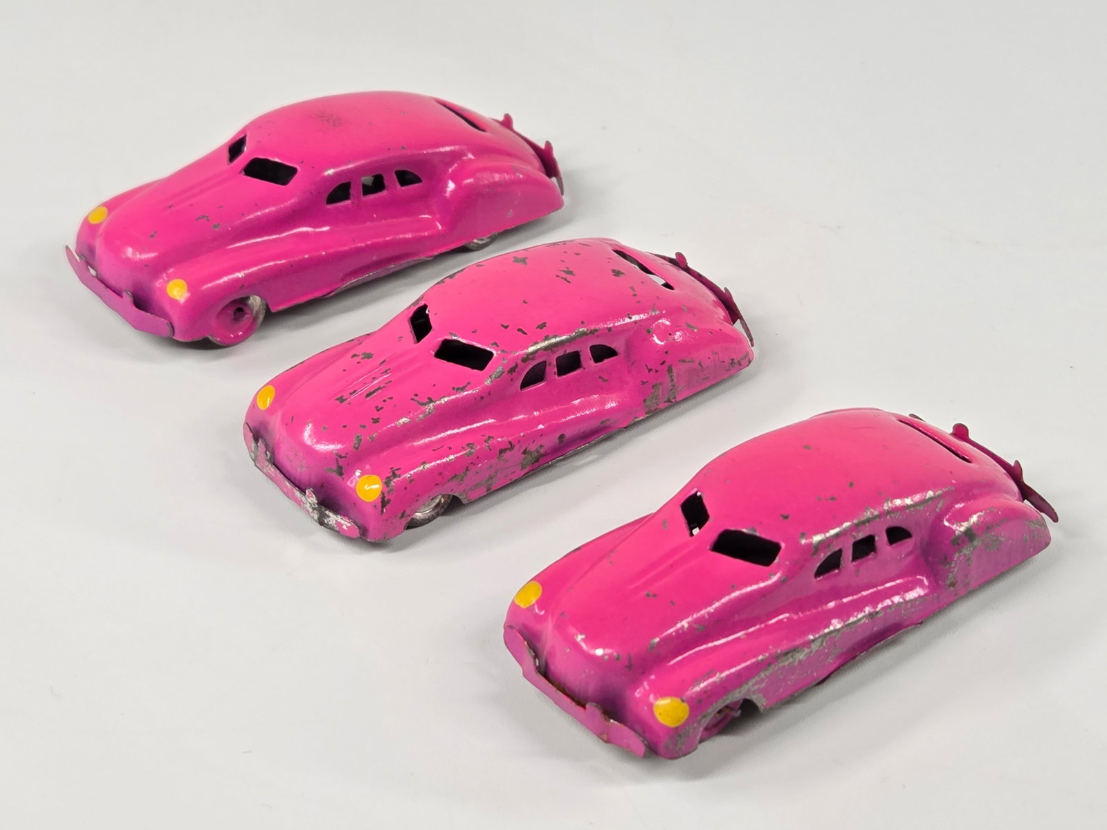 3) SMALL MINIATURE PINK OCCUPIED JAPAN TIN LITHO CARS: ALL REMAIN IN GOOD CONDITION, SHOWING SOME PAINT WEAR.