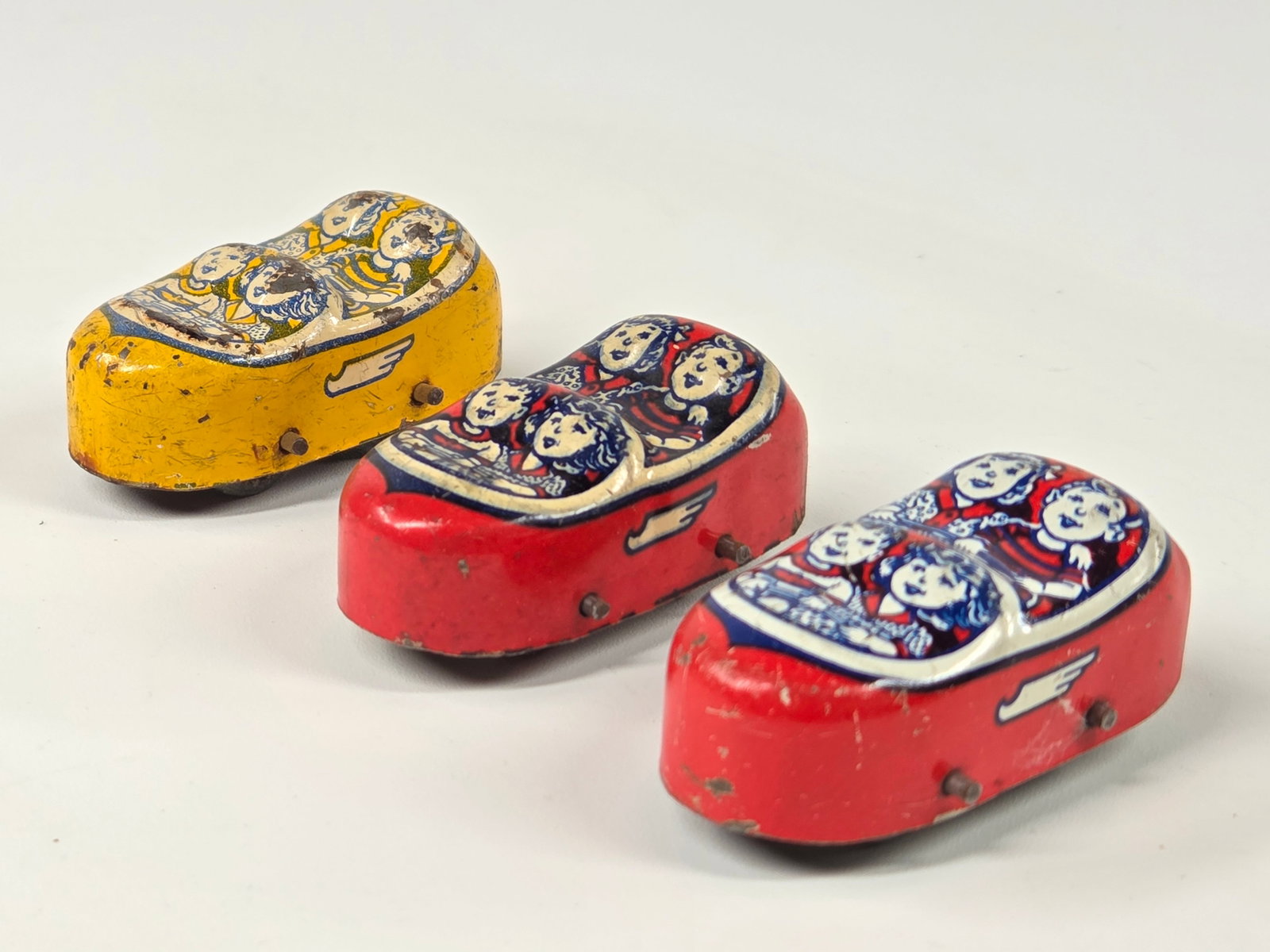 3) SMALL J. CHEIN TIN LITHO ROLLER COASTER CARS: ALL REMAIN IN GOOD CONDITION, THE YELLOW SHOWING SOME WEAR.