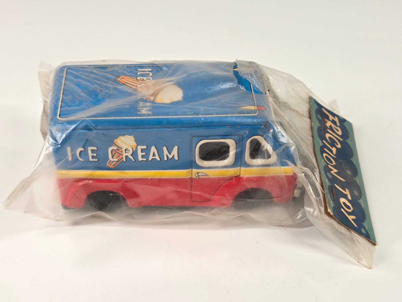 VINTAGE JAPAN TIN FRICTION ICE CREAM TRUCK NIP: REMAINS NEW IN PACKAGE, PACKAGING SHOWING SOME WEAR.