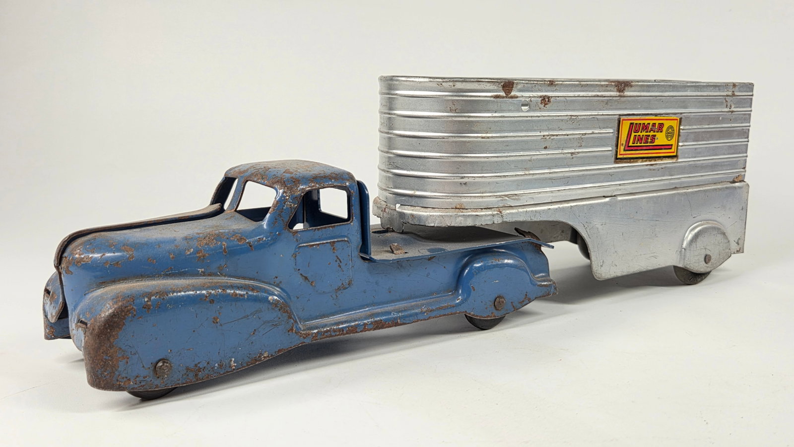 LUMAR MARX PRESSED STEEL LUMAR LINES TRUCK: REMAINS IN FAIR CONDITION, SHOWING TYPICAL WEAR THROUGHOUT. MISSING GRILL BUMPER PIECE ON CAB.