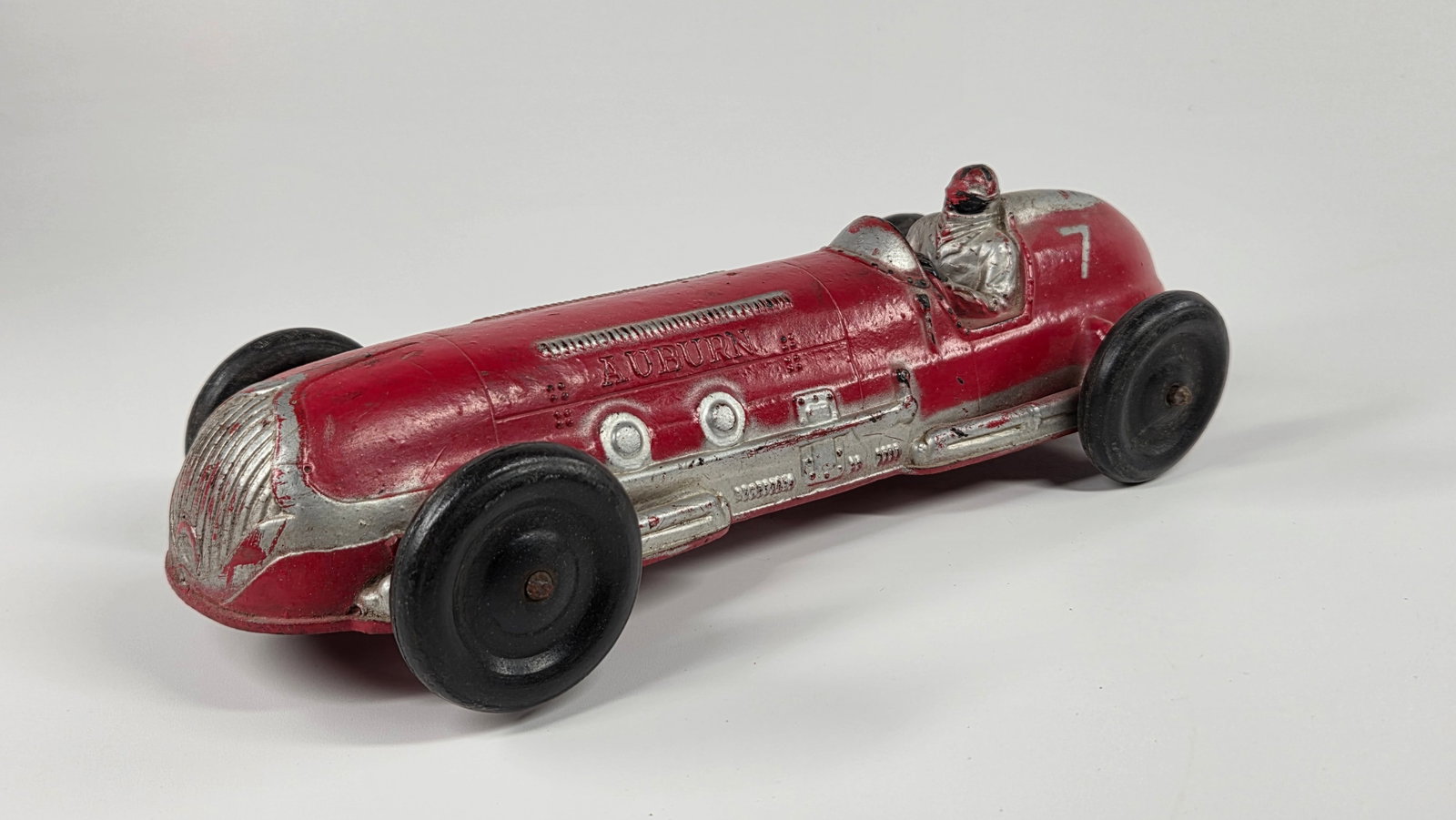 LARGE AUBURN RUBBER OPEN WHEEL RACE CAR: REMAINS IN GOOD CONDITION, SHOWING SOME TYPICAL WEAR.