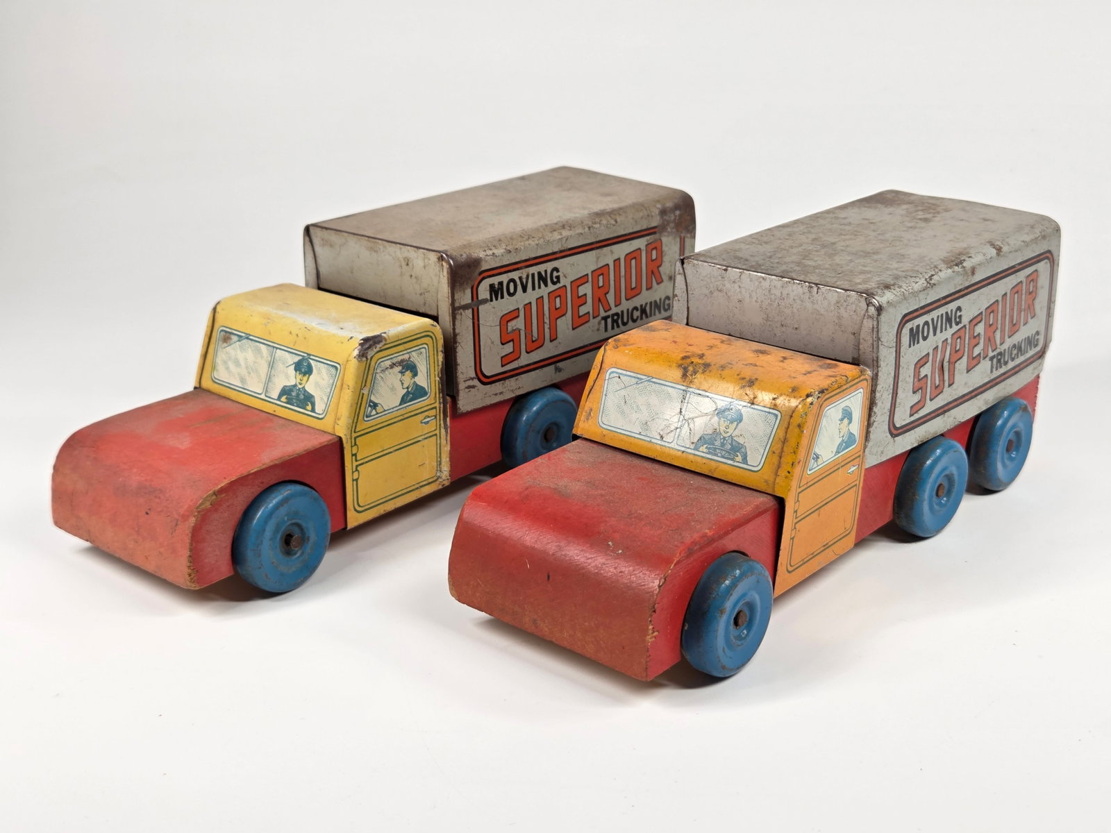 2) WOOD & PRESSED STEEL SUPERIOR MOVING TRUCKS: BOTH REMAIN IN FAIR TO GOOD CONDITION, SHOWING TYPICAL WEAR THROUGHOUT.