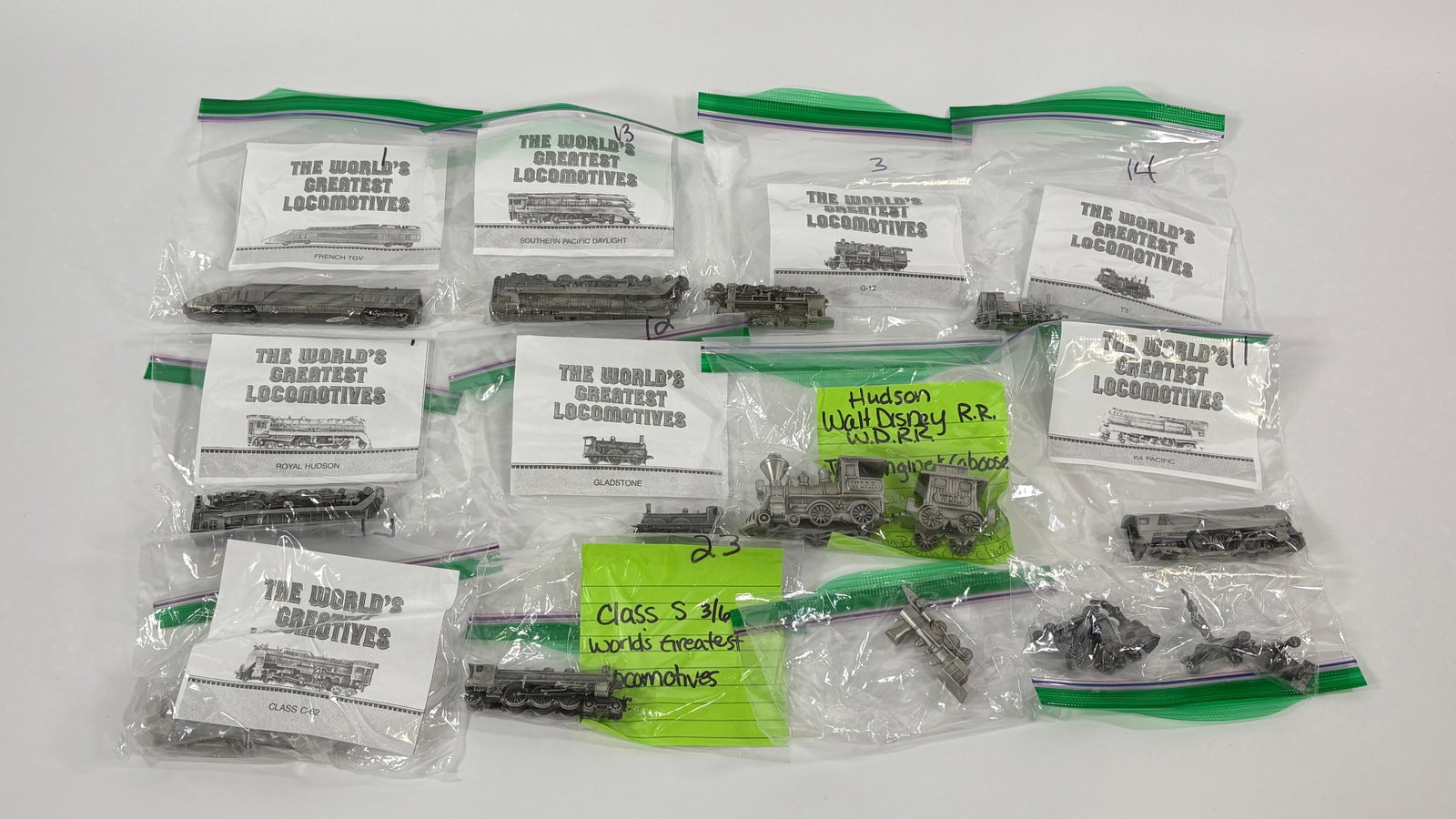 23-PIECE FRANKLIN MINT WORLD'S GREATEST RAILROAD ENGINES SET: ALL REMAIN IN VERY GOOD CONDITION. SOME WITH ORIGINAL BOX AND COA. ALSO INCLUDES A MINIATURES ELVIS DECANTER AND SMALL TRAIN BANK.