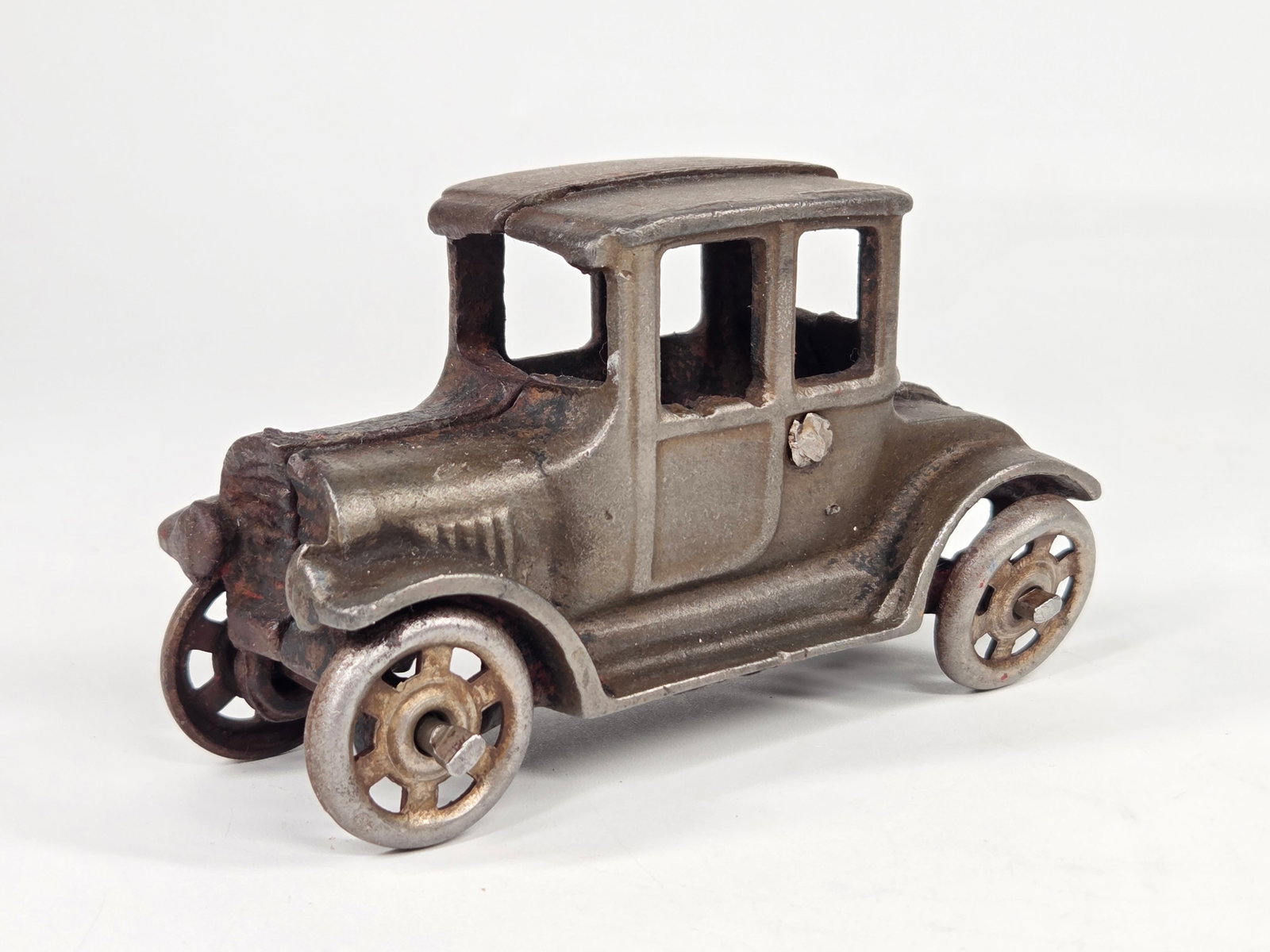 AC WILLIAMS CAST IRON FORD MODEL T COUPE: REMAINS IN FAIR CONDITION, SHOWING PAINT WEAR THROUGHOUT.