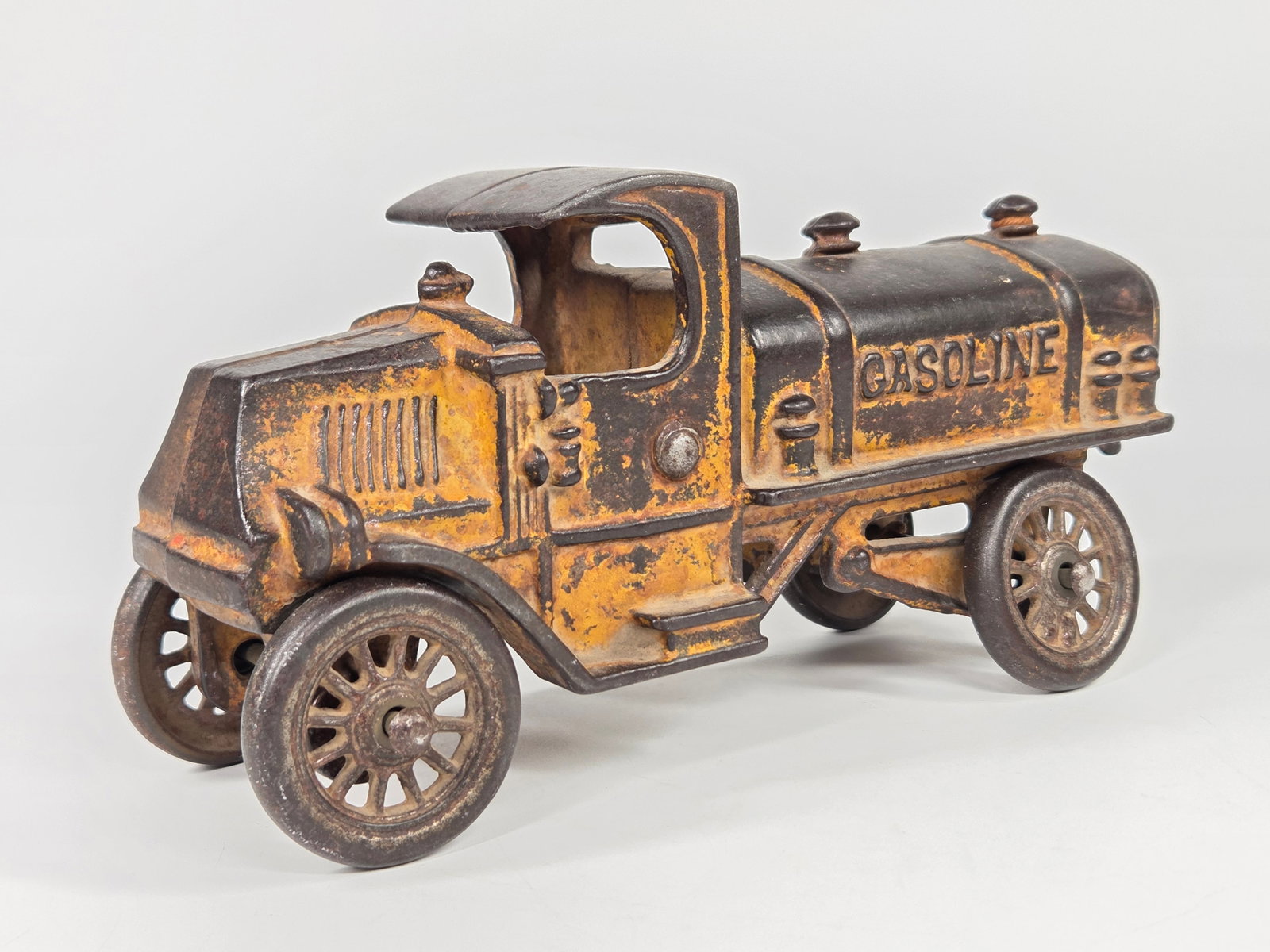 CAST IRON MACK CAB GASOLINE TANKER TRUCK: REMAINS IN FAIR CONDITION, SHOWING PAINT WEAR.