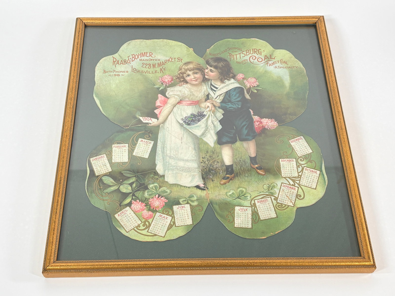 1904 VICTORIAN DIE-CUT 4 LEAF CLOVER PITTSBURG COAL AD: GOOD CONDITION, BRIGHT, FRAMED DIE-CUT WITH SOME GENERAL WEAR INCLUDING LIGHT MARKS AND 2 BREAKS AT THE BOTTOM