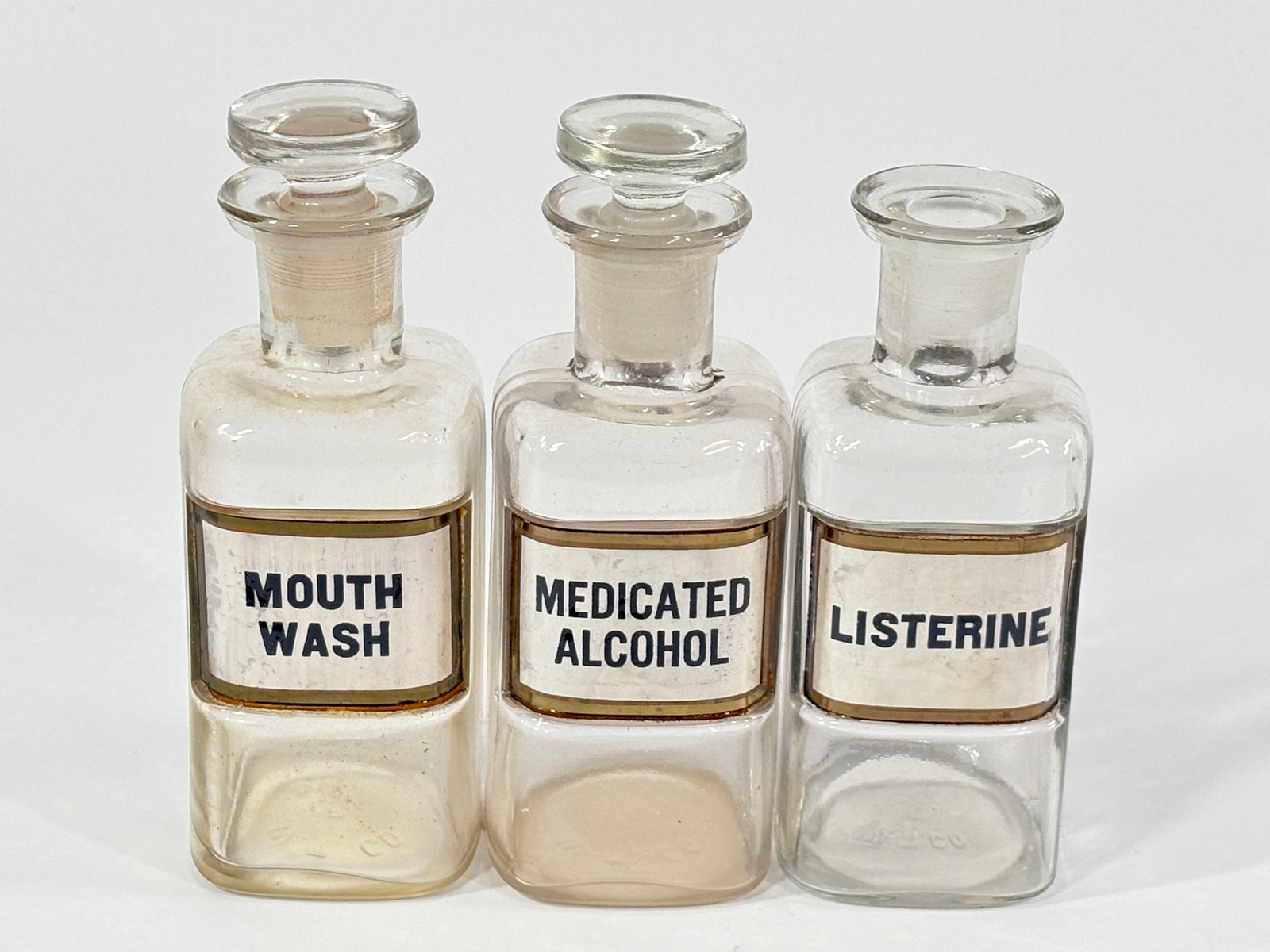 GLASS APOTHECARY DENTAL BOTTLES - MOUTHWASH, LISTERINE, ALCOHOL: COLLECTION REMAINS IN GOOD CONDITION WITH NICE LABELS - MISSING ONE STOPPER