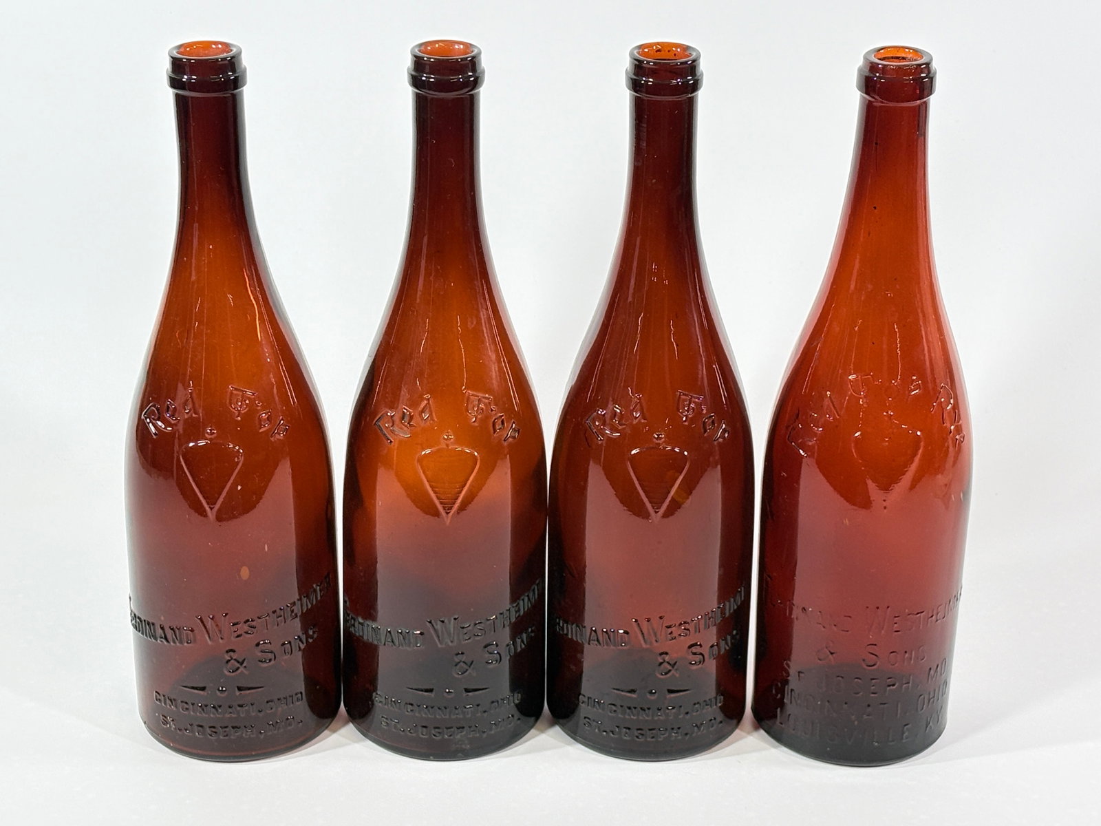 4) PRE-PROHIBITION GLASS RED TOP RYE WHISKEY BOTTLES WESTHEIMER: GROUP REMAINS IN VERY GOOD CLEAN CONDITION WITH NO NOTABLE MARKS OR WEAR
