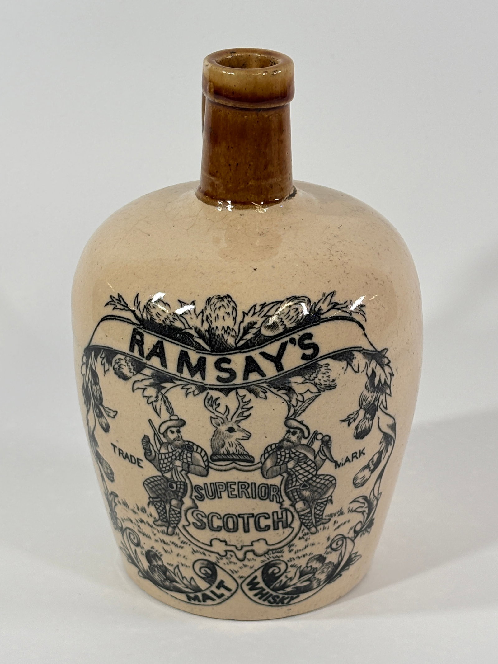 RAMSAY'S SUPERIOR SCOTCH MALT WHISKY 2 TONE STONEWARE JUG: STONEWARE REMAINS IN VERY GOOD CONDITION WITH NO NOTABLE MARKS - LIGHT WEAR, MINOR CRAZING. ATTRACTIVE TRANSFER ILLUSTRATION.