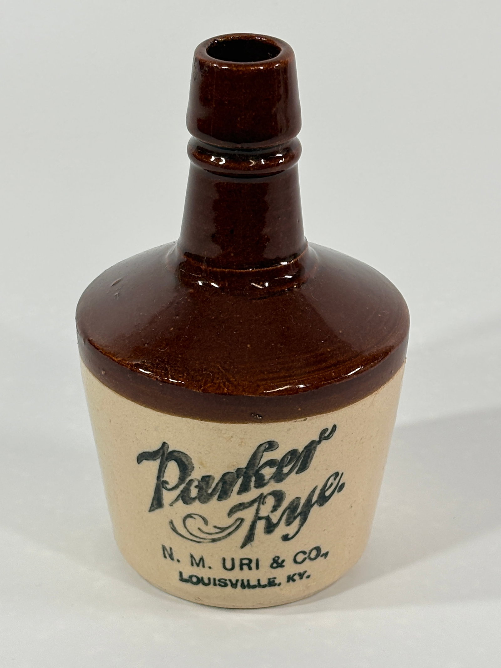 PARKER RYE 2 TONE BROWN STONEWARE WHISKEY JUG: STONEWARE REMAINS IN VERY GOOD CONDITION WITH NO NOTABLE MARKS