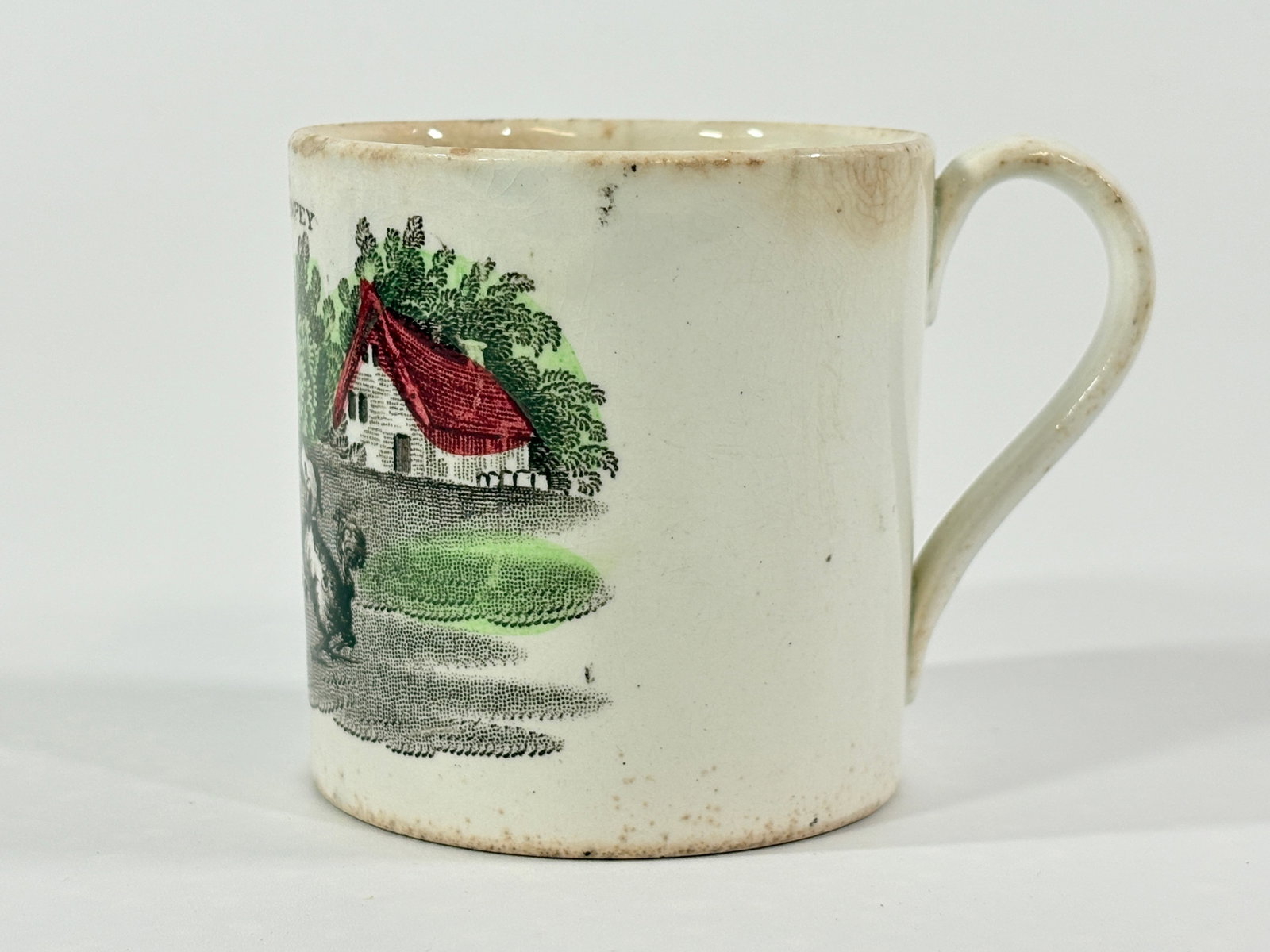 ANTIQUE TRANSFER DECORATED "PLAYING WITH POMPEY" CHILD'S MUG: REMAINS IN FAIR CONDITION, SHOWING TYPICAL USAGE WEAR. SMALL REPAIRED CHIP ALONG BOTTOM EDGE.