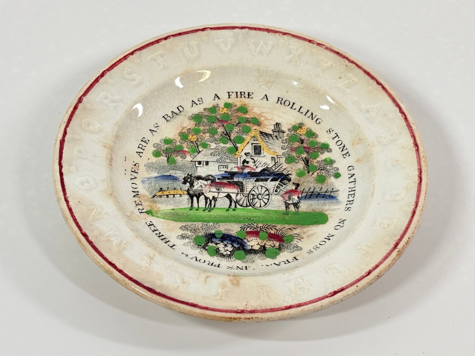 ANTIQUE TRANSFER DECORATED STAFFORDSHIRE ABC PLATE: REMAINS IN GOOD CONDITION, SHOWING WEAR. STAINS PRESENT. NO CHIPS OR CRACKS.