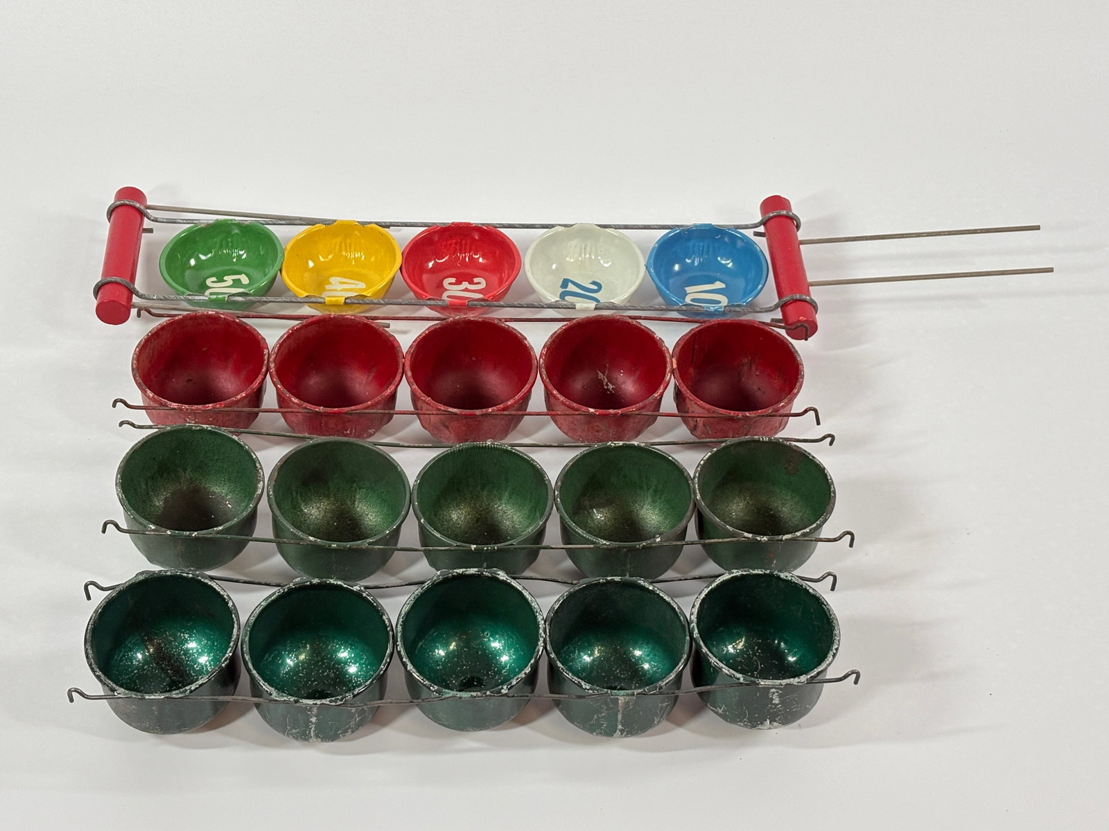 4) ANTIQUE METAL MARBLE GAME PIECES: ALL REMAIN IN GOOD CONDITION, SHOWING SOME TYPICAL USAGE WEAR.